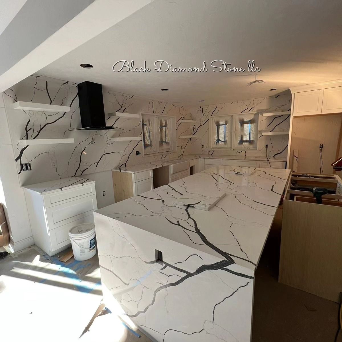 a kitchen is being remodeled with marble countertops and cabinets