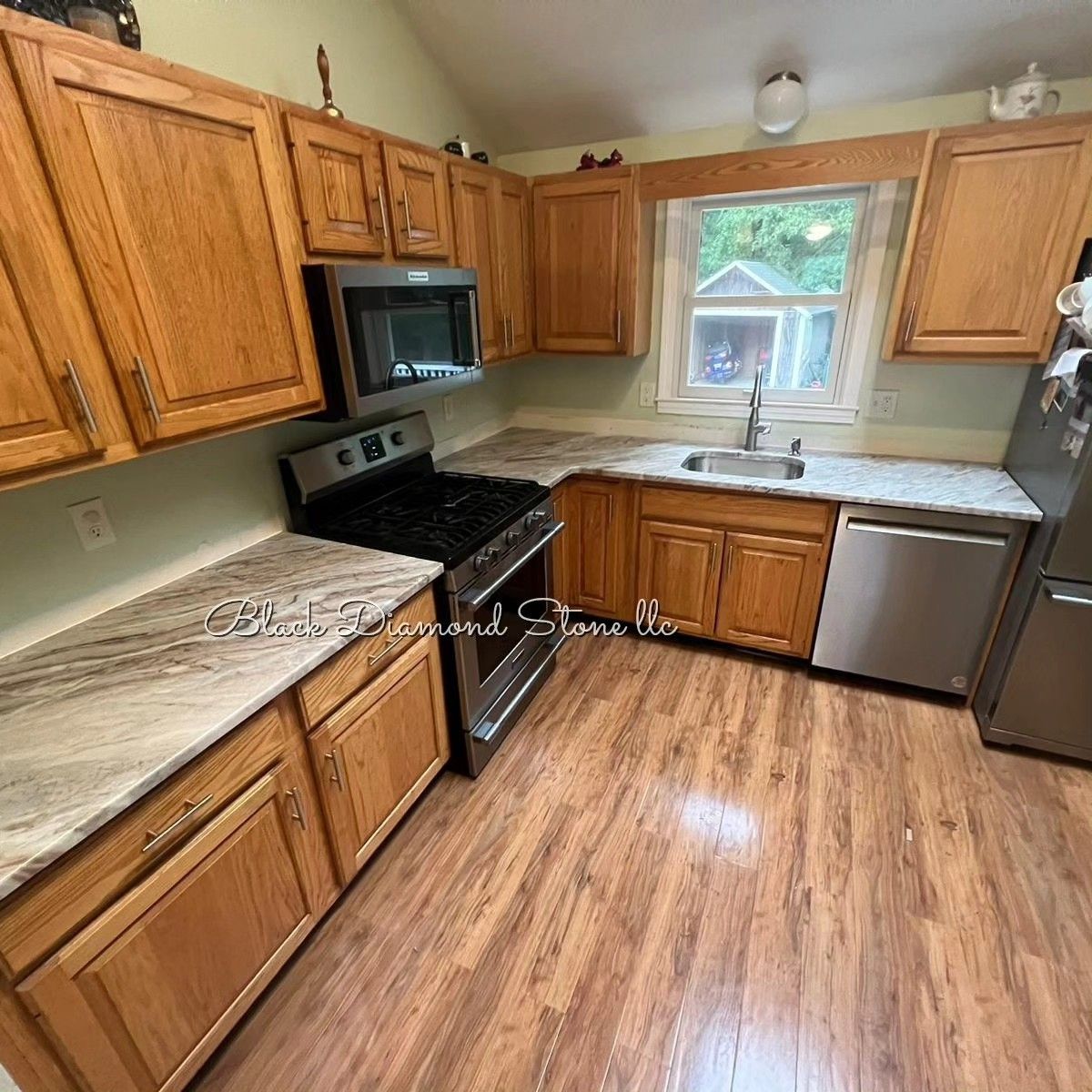 a kitchen with wooden cabinets, stainless steel appliances and granite countertops