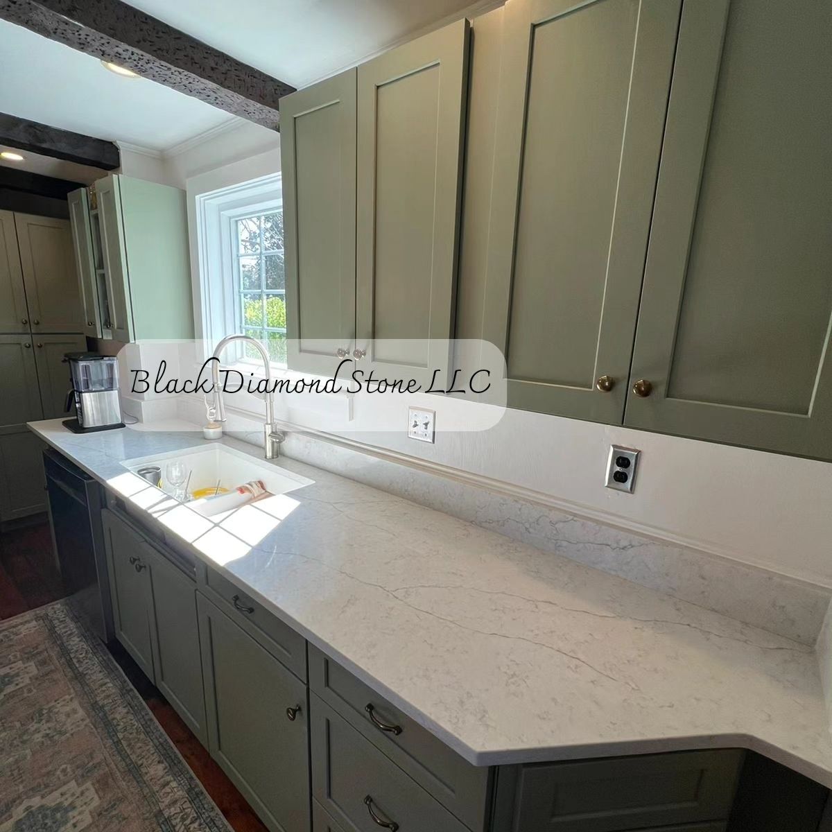 a kitchen with green cabinets and white countertops 