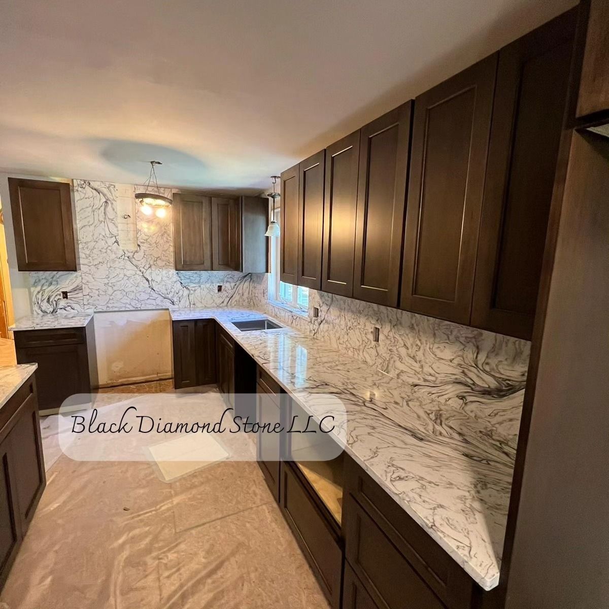 a kitchen with marble countertops and wooden cabinets