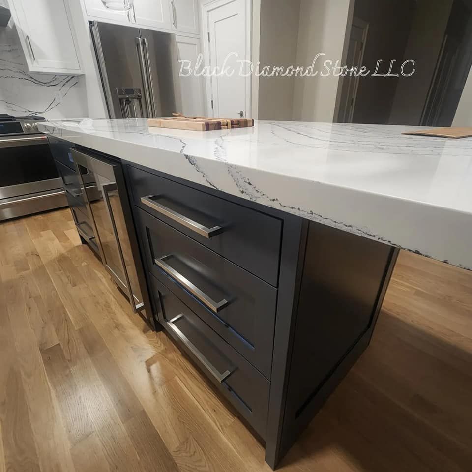a kitchen with a marble countertop and stainless steel appliances