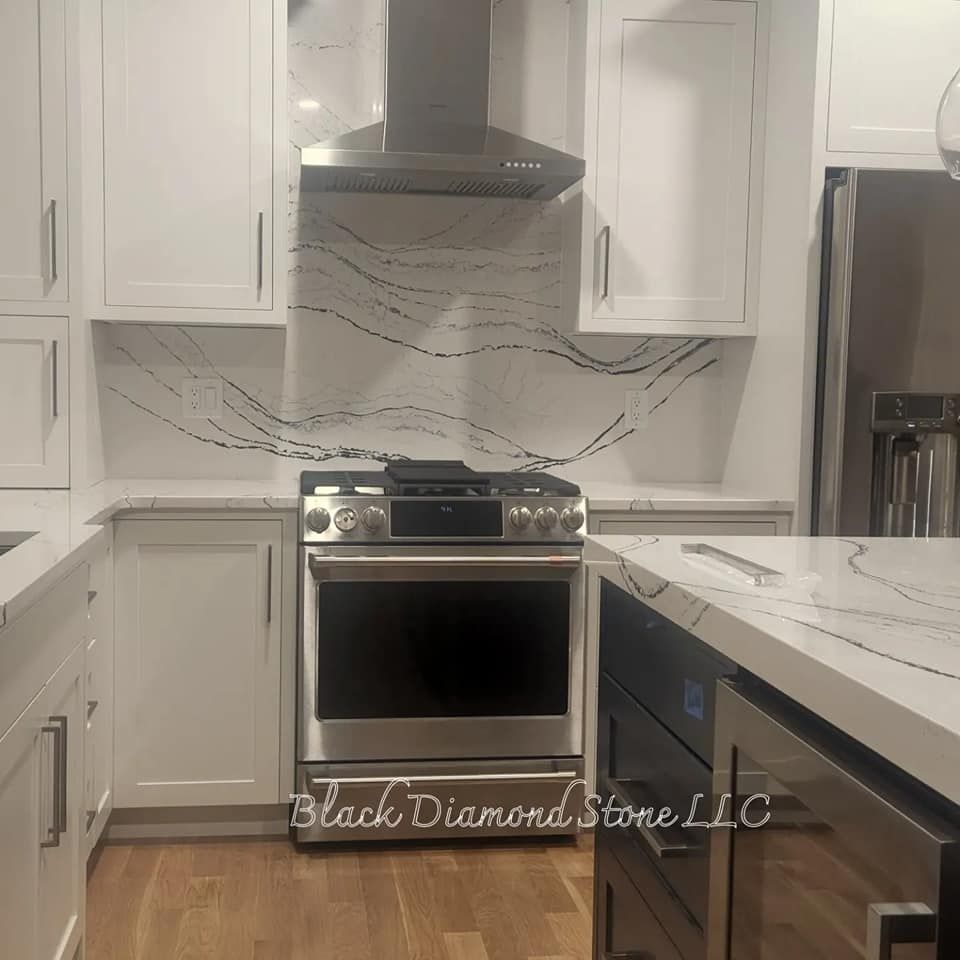 a kitchen with white cabinets and stainless steel appliances