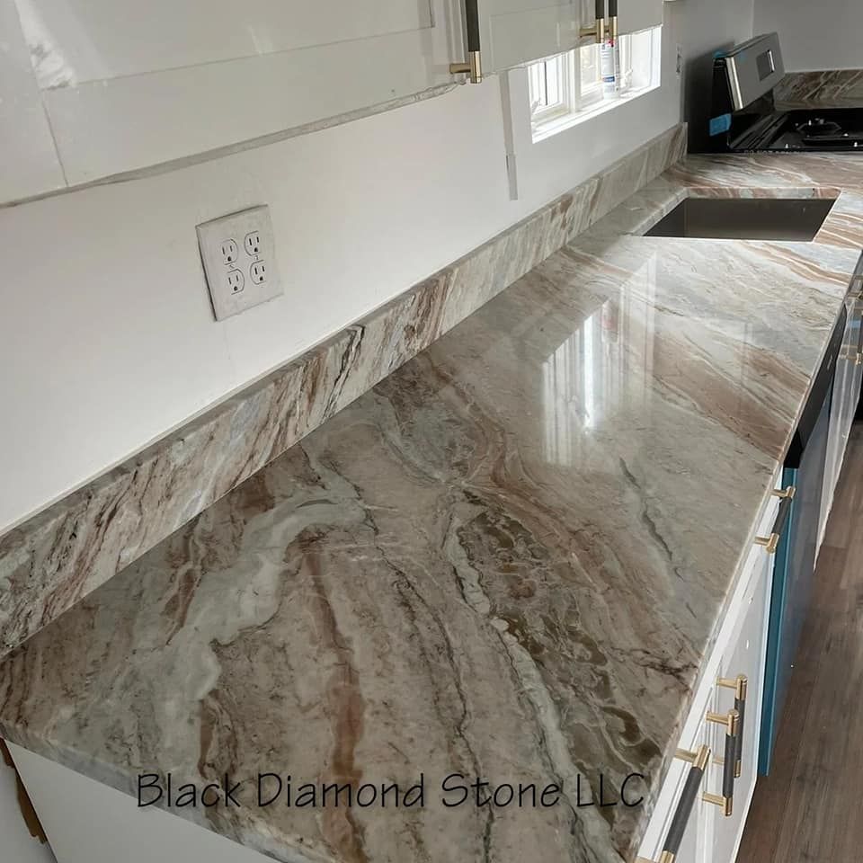 a kitchen with a granite countertop and white cabinets