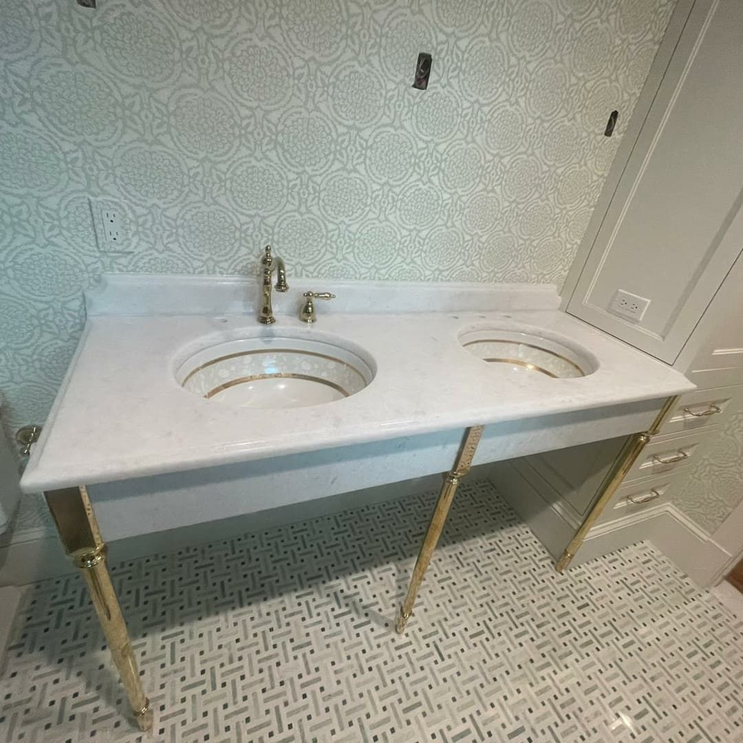 a bathroom with two sinks and a tiled floor