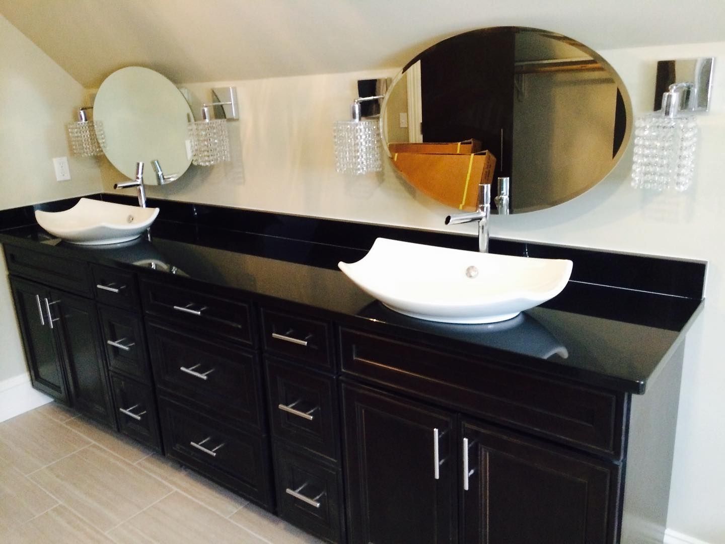 a bathroom with two sinks and two mirrors