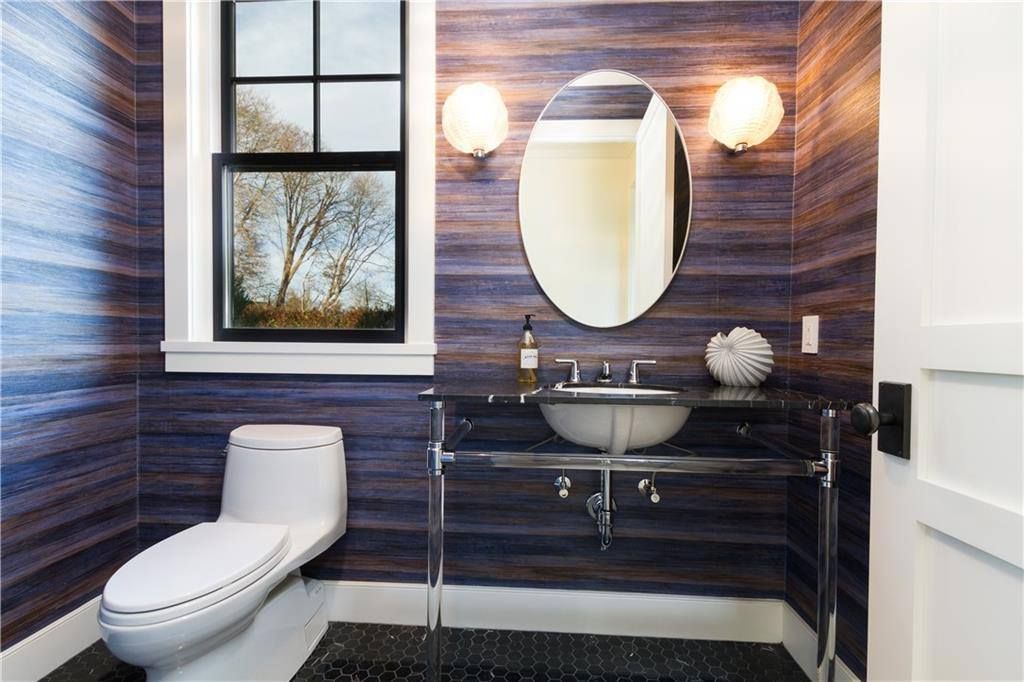 a bathroom with a toilet a sink and a mirror