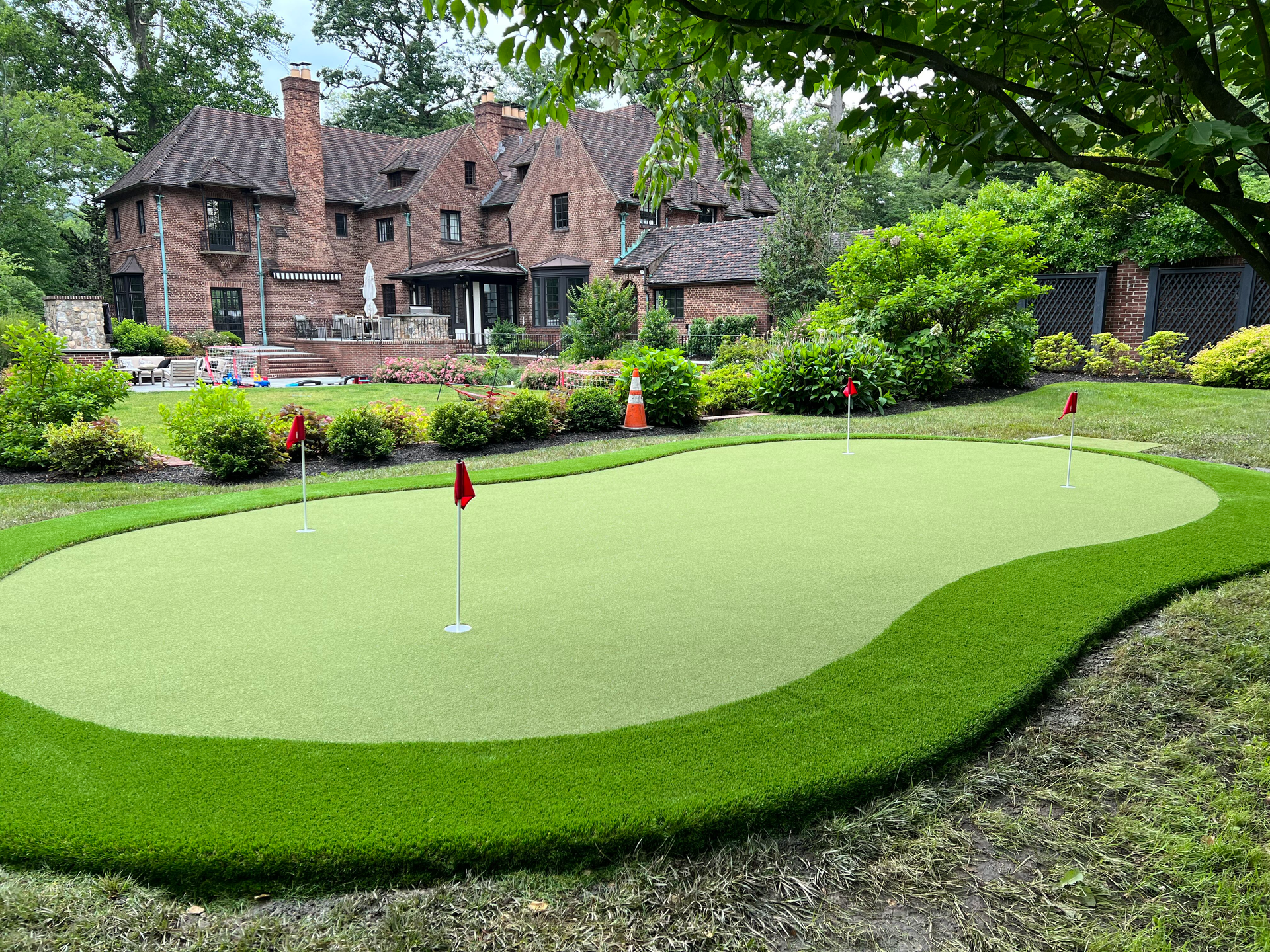 A lawn with an artificial & Synthetic golf putting green in Mendham, NJ 07945