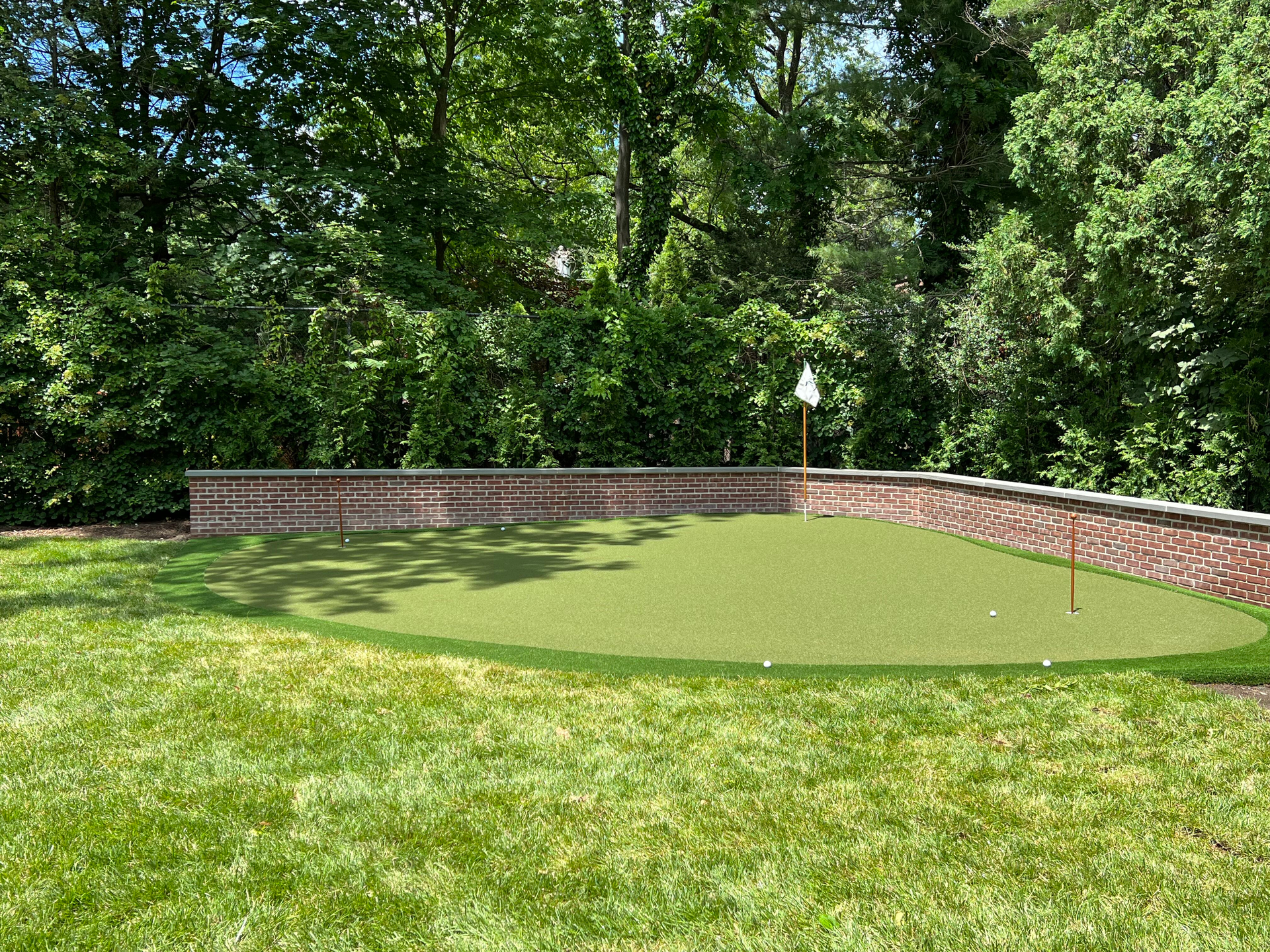 A lawn with an artificial & Synthetic golf putting green in Mendham, NJ
