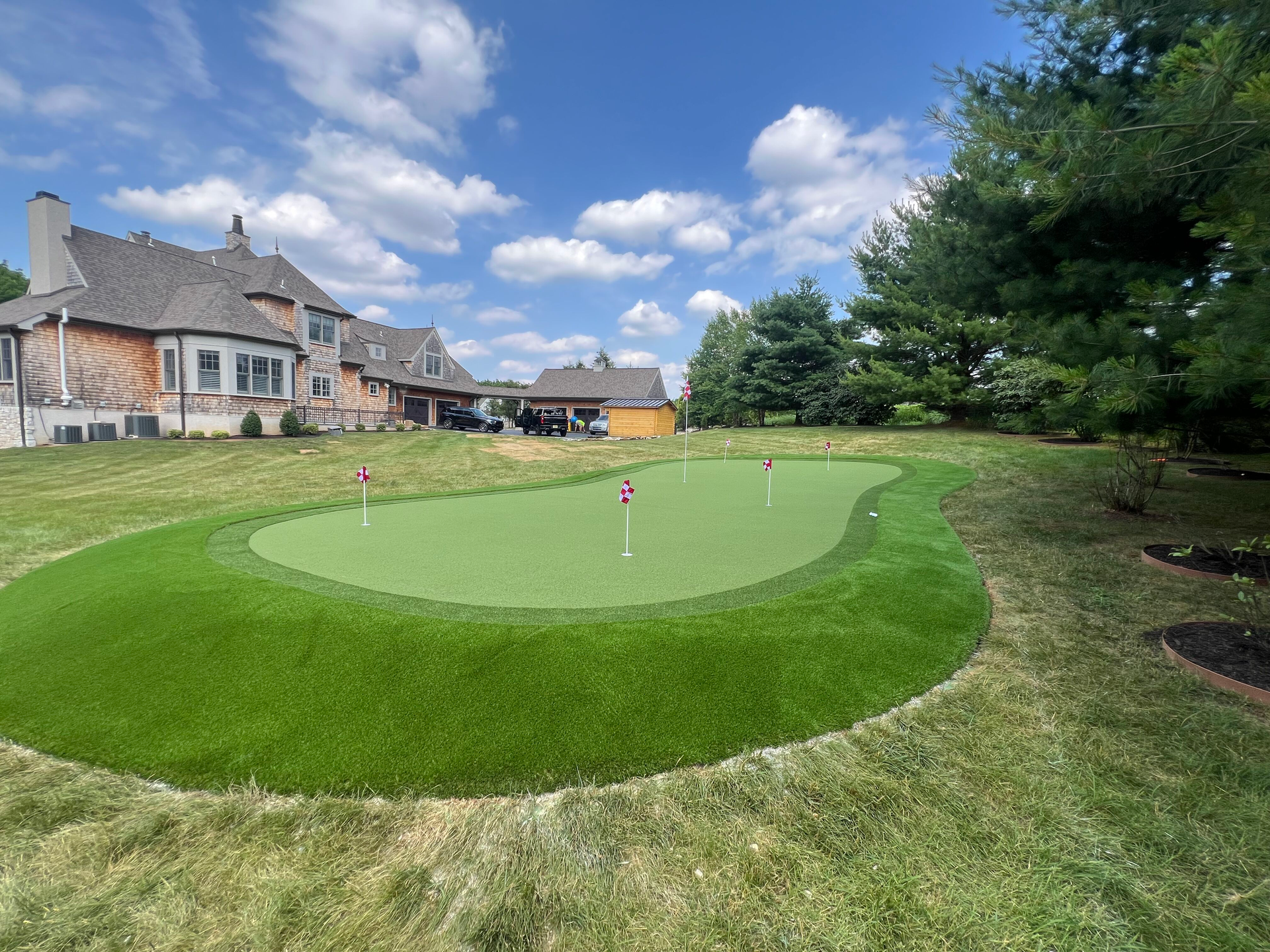 A lawn with an artificial & Synthetic golf putting green in Mendham, NJ 07945