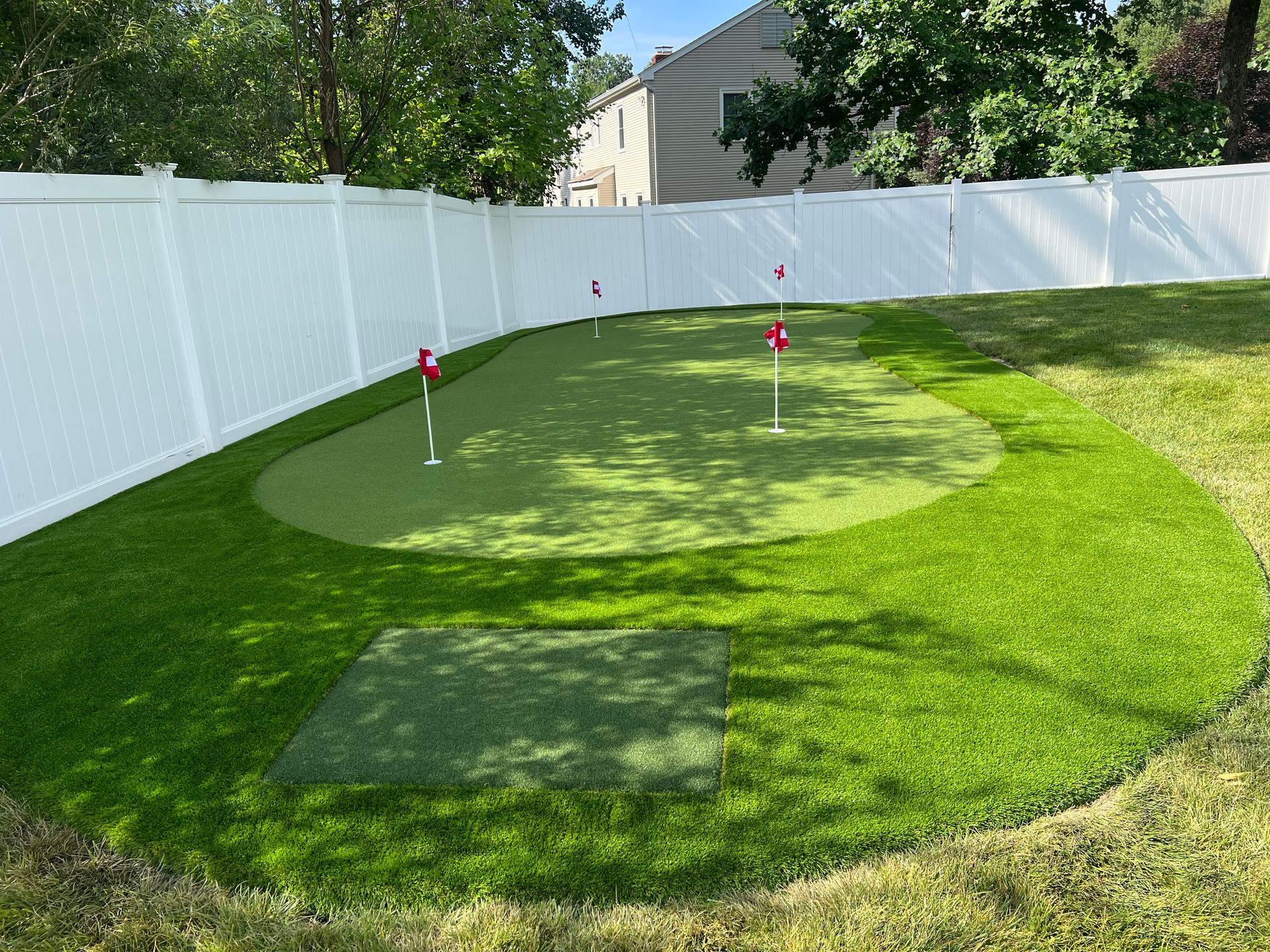 A lawn with an artificial & Synthetic golf putting green in Mendham, NJ 07945
