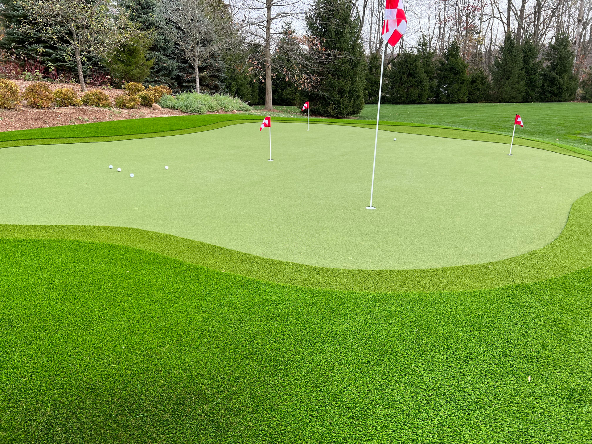 A lawn with an artificial & Synthetic golf putting green in Mendham, NJ