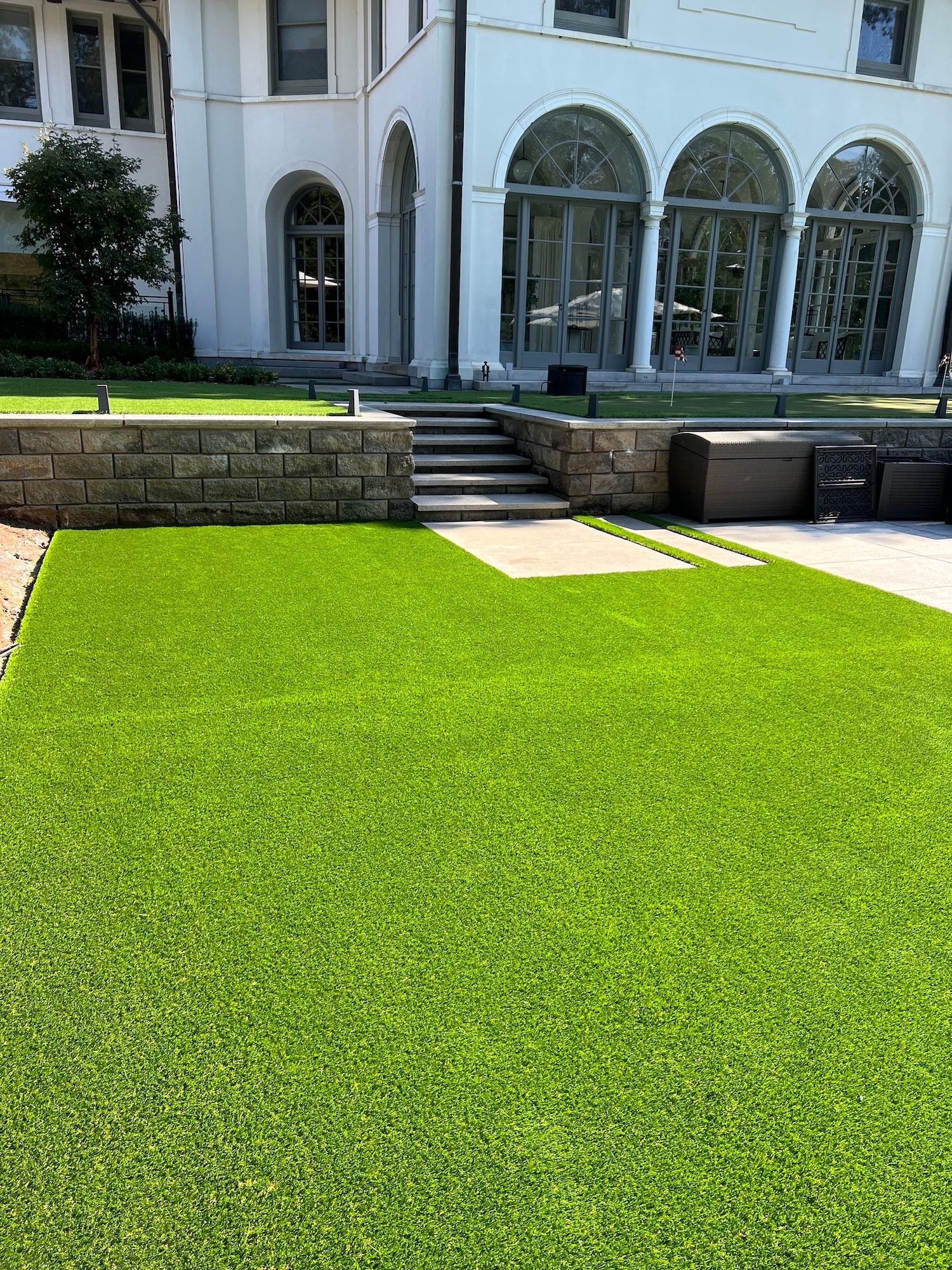 A large white house with a large lawn in front of it.