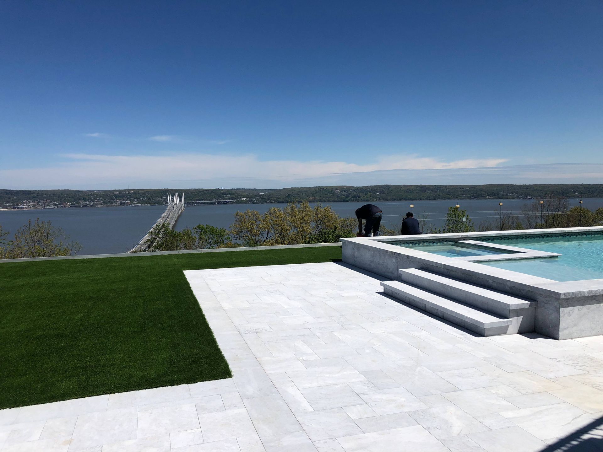 A swimming pool with a view of a body of water.