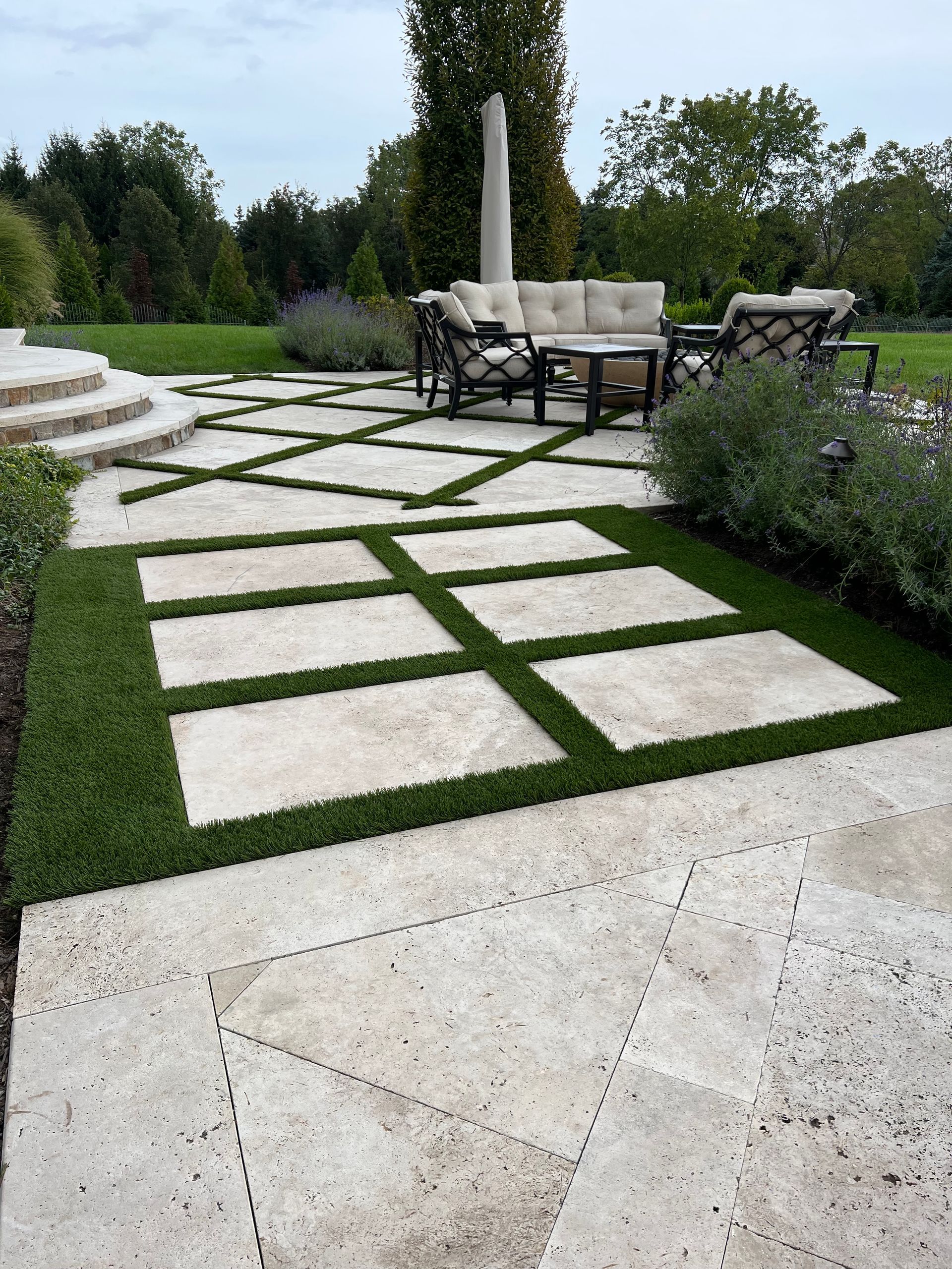 A patio with a couch and chairs on it.