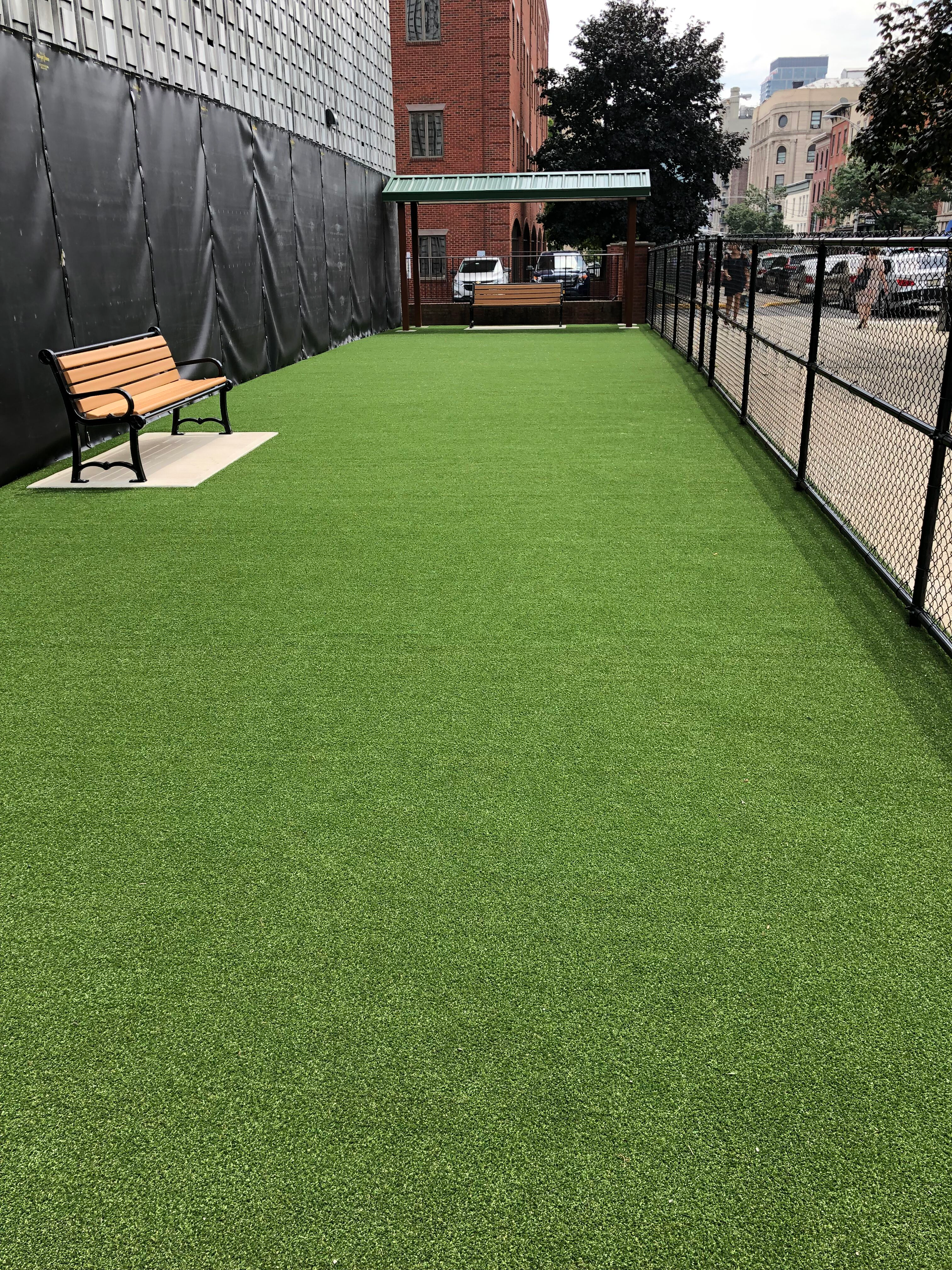 There is a bench in the middle of the grass.