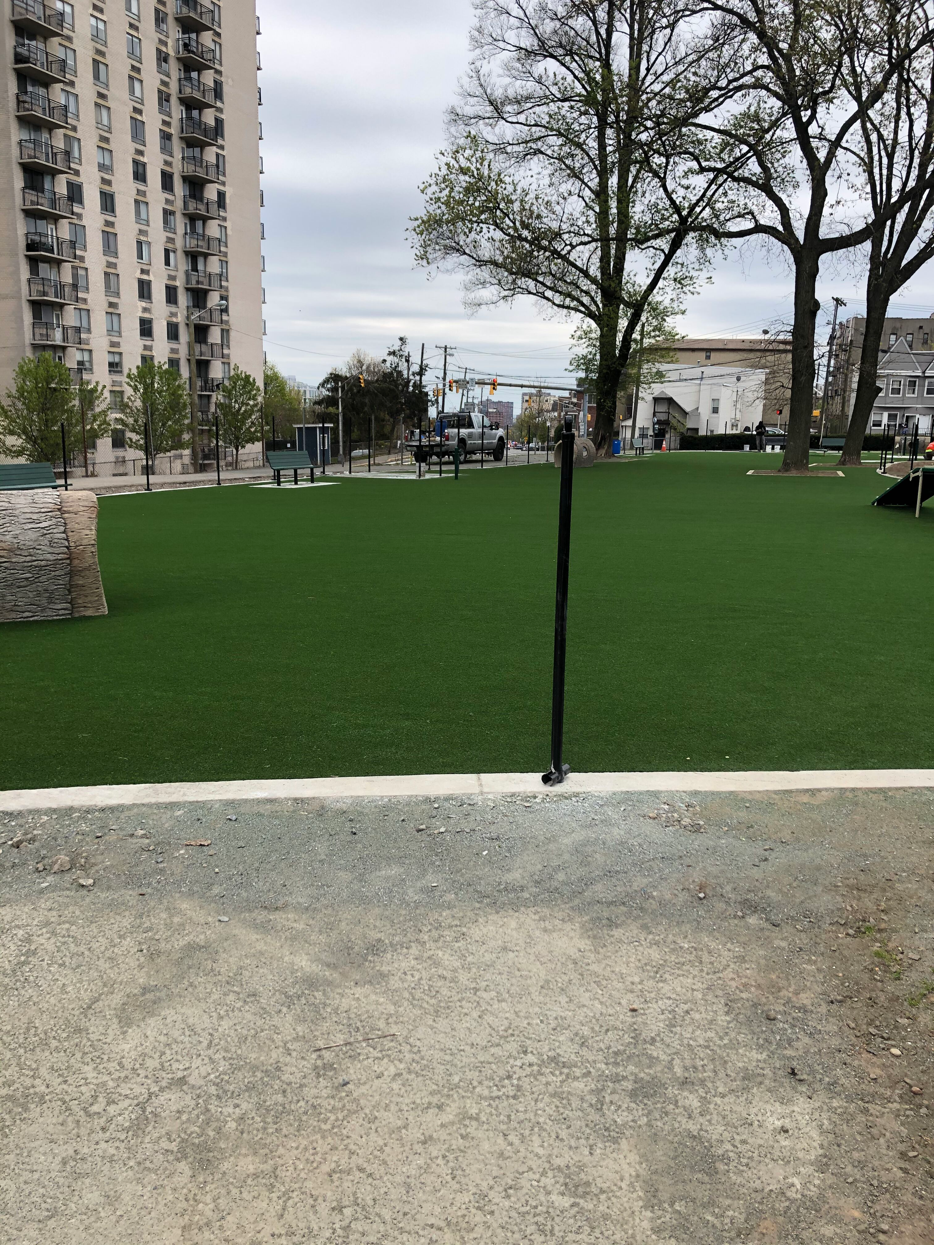 A park with a lot of grass and trees in the background.