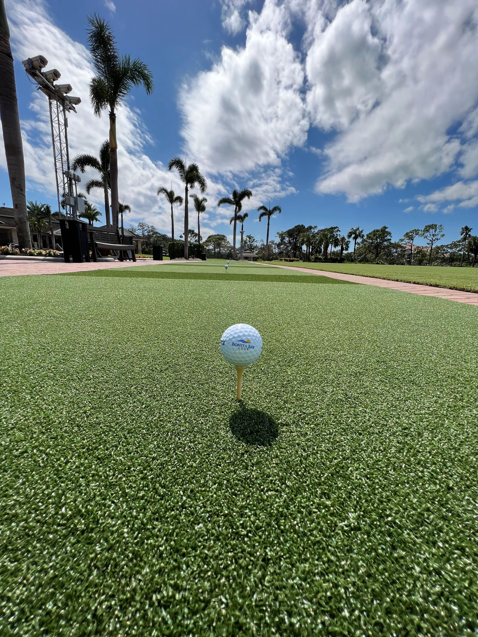 A golf ball is on a tee on a golf course.