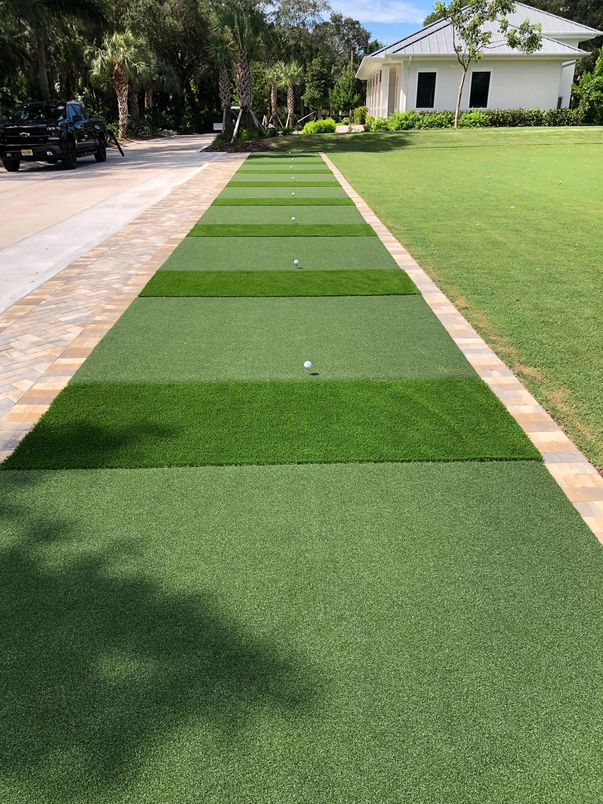 There is a golf course in the middle of the driveway.