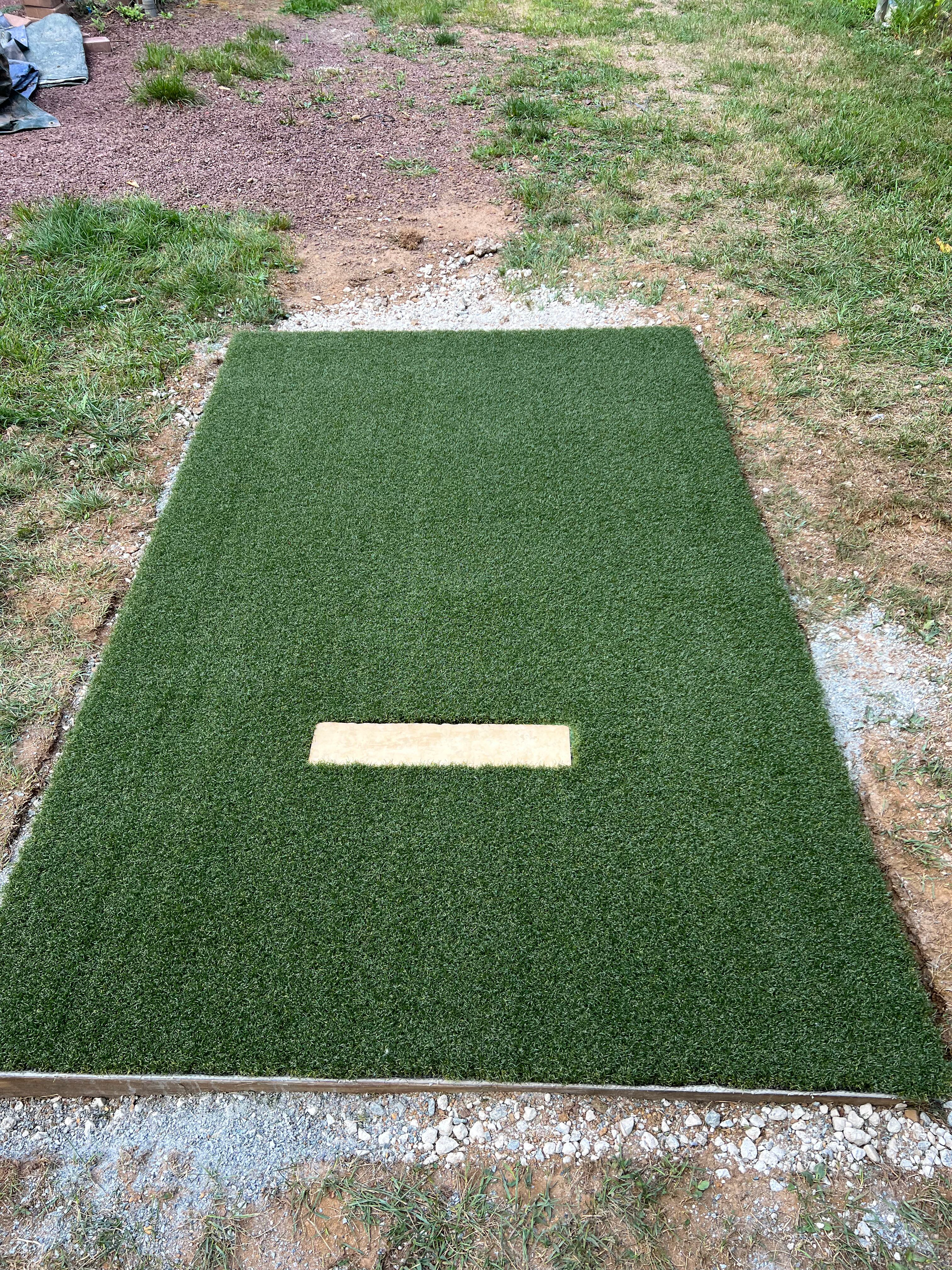 A baseball field with a base in the middle of it.