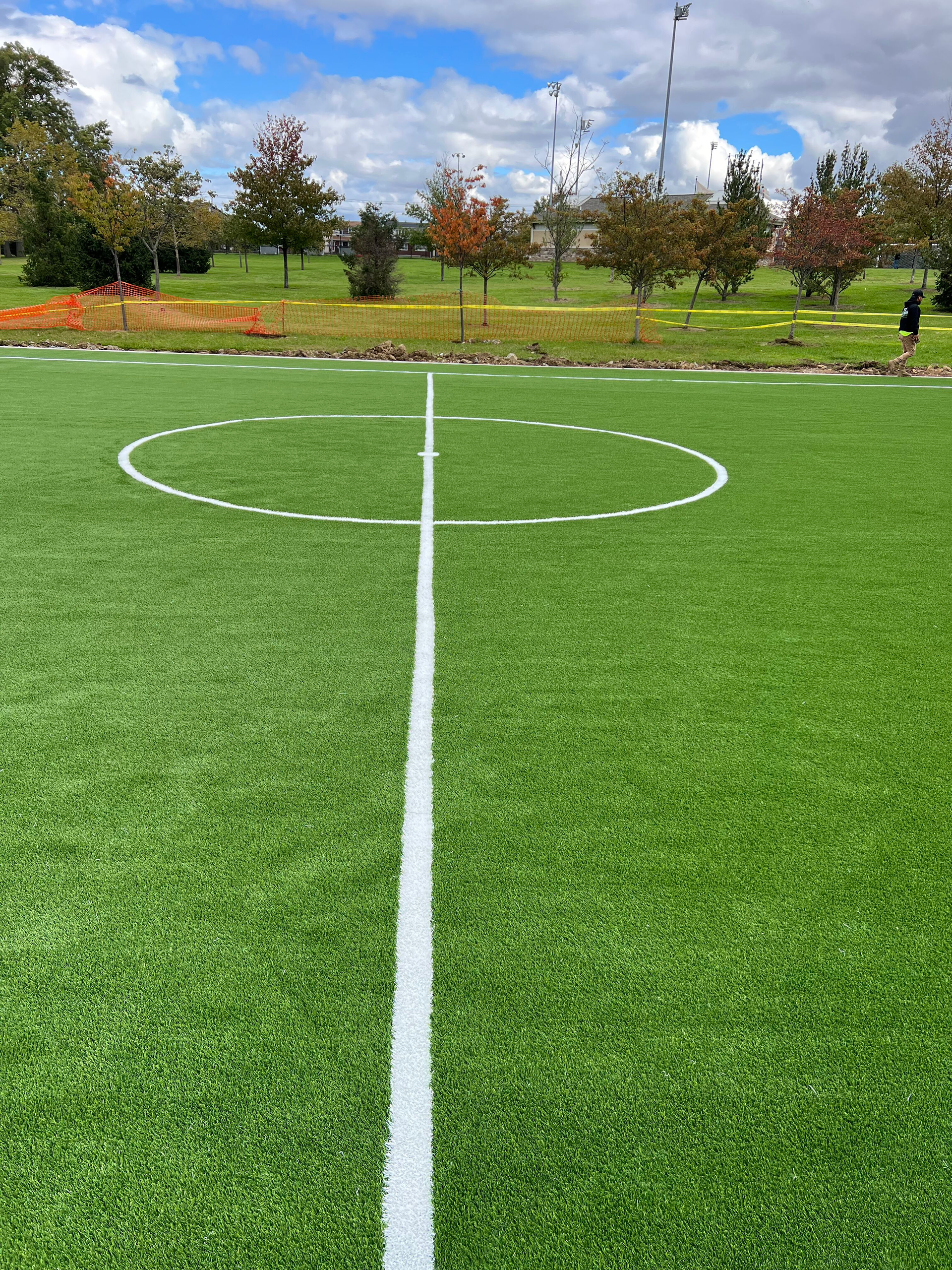 A soccer field with a white line in the middle of it.