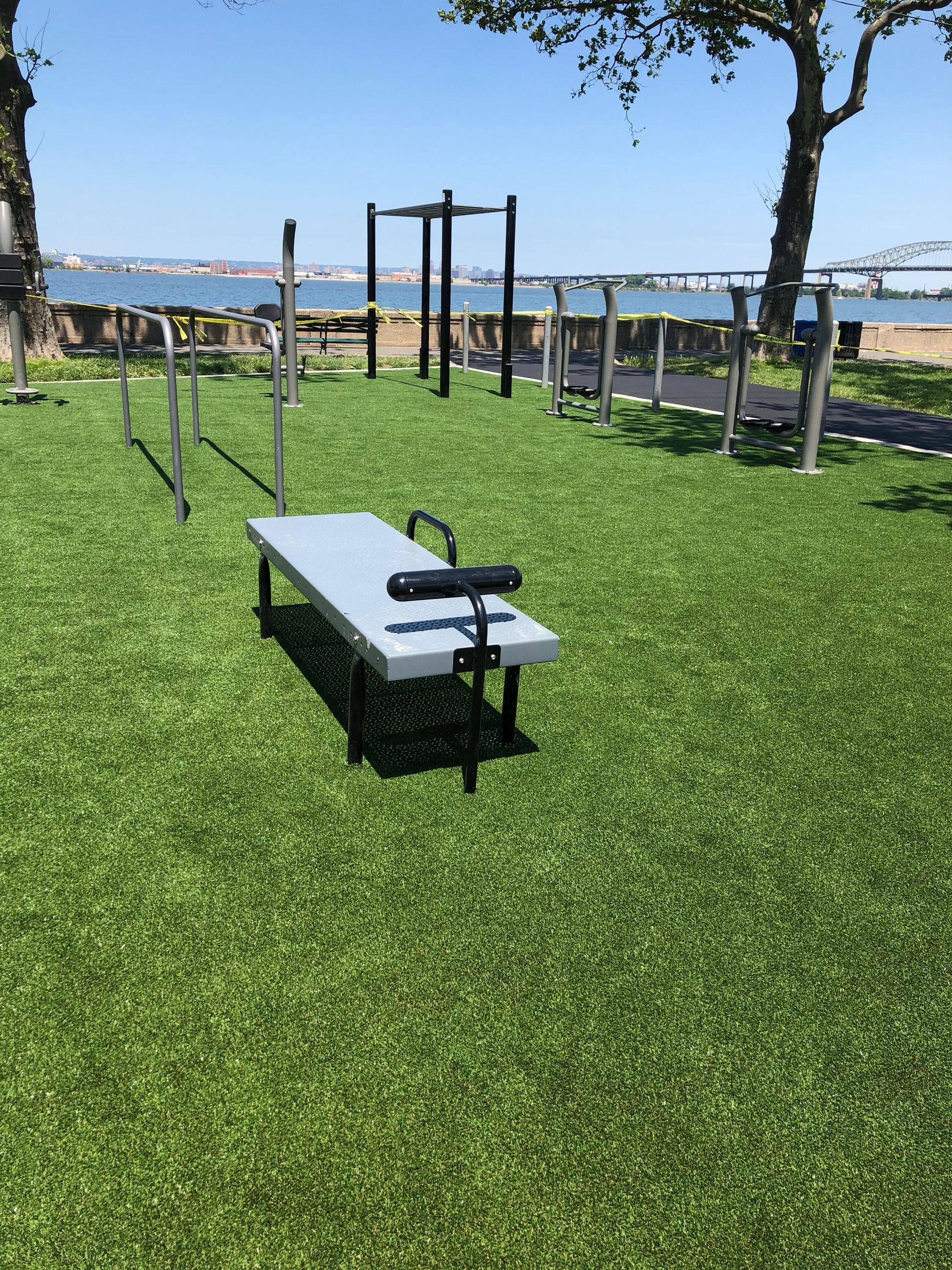 A bench is sitting on top of a lush green field.