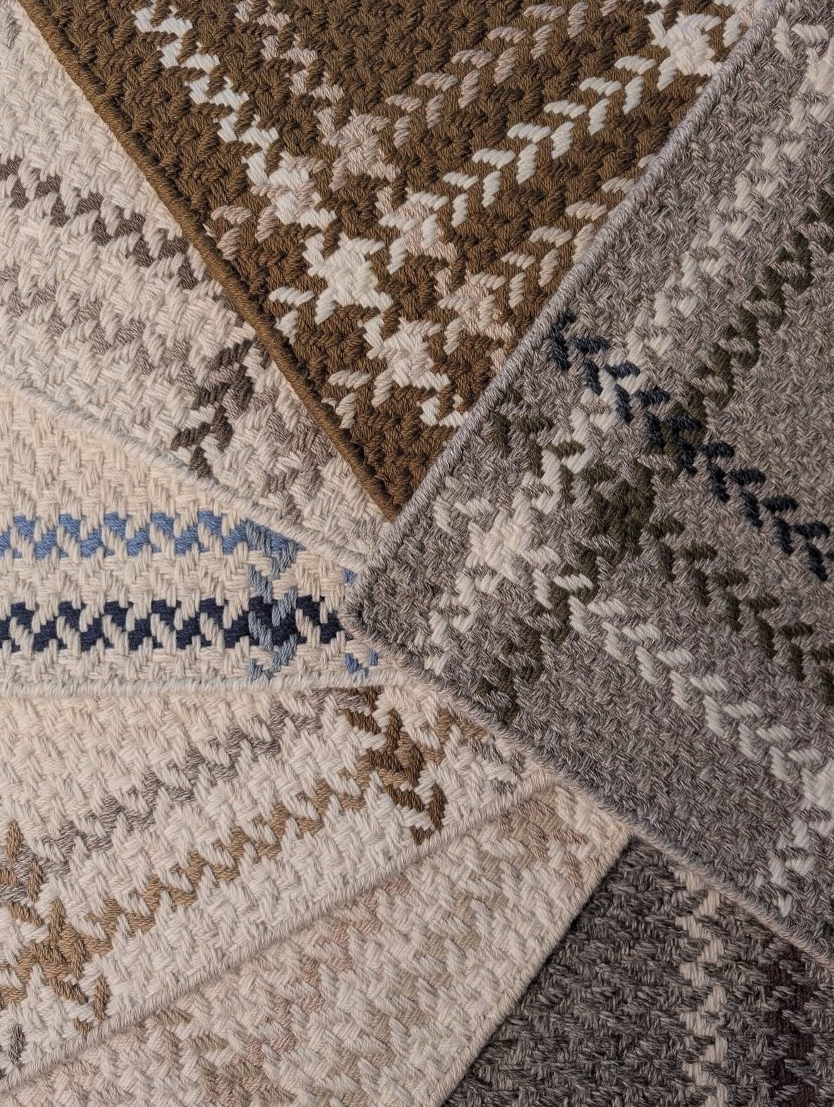 Close-up of patterned carpet samples in various neutral colors, arranged in a starburst pattern.