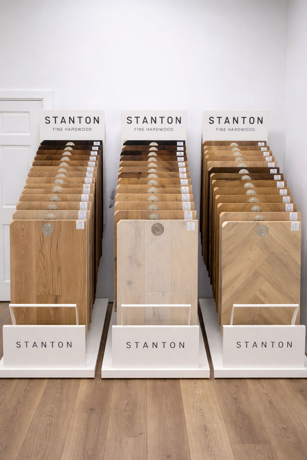 Three Stanton display racks featuring varied wood flooring samples in a showroom