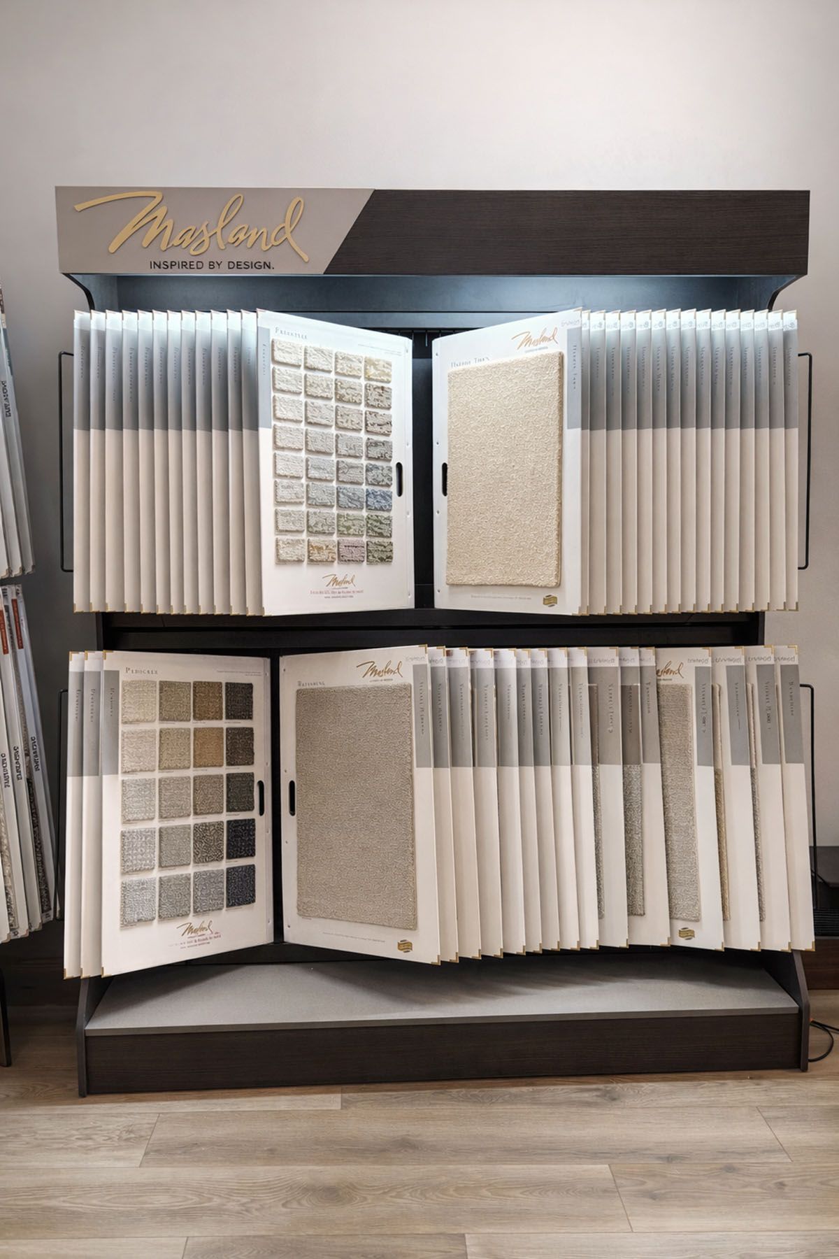 A display stand with numerous swatches in various neutral shades of beige and gray