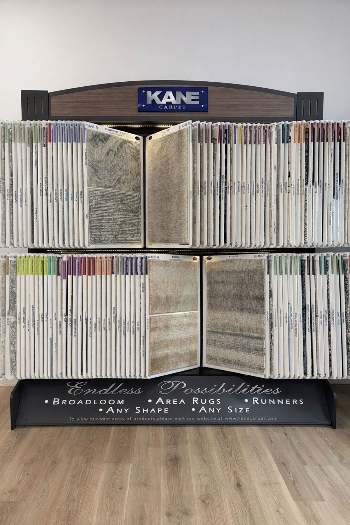 A carpet display rack featuring rows of hanging carpet and rug samples