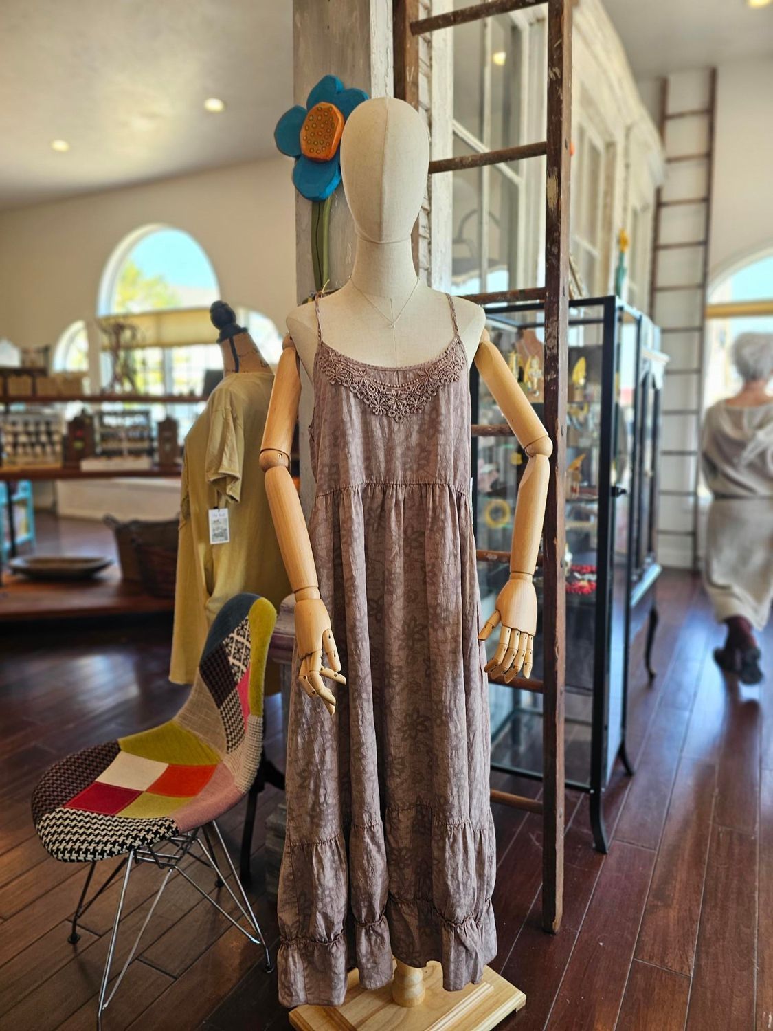 A mannequin is wearing a dress in a store.