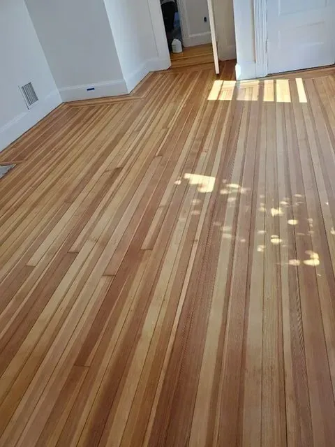 A room with a wooden floor and white walls.