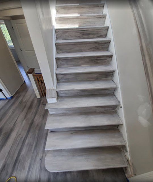 A staircase with a wooden floor in a house.