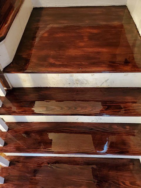 A close up of a wooden staircase with a white railing.