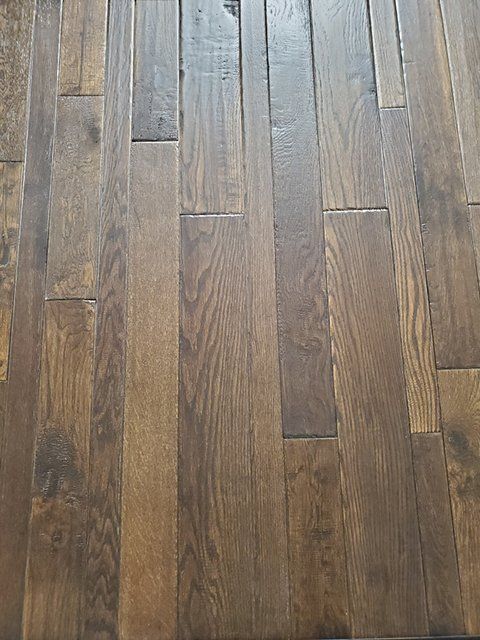 A close up of a wooden floor in a room.
