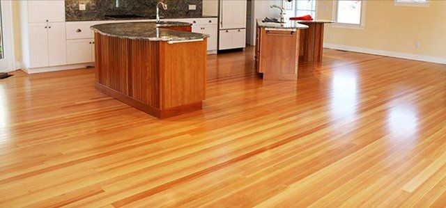 A kitchen with hardwood floors and a large island.