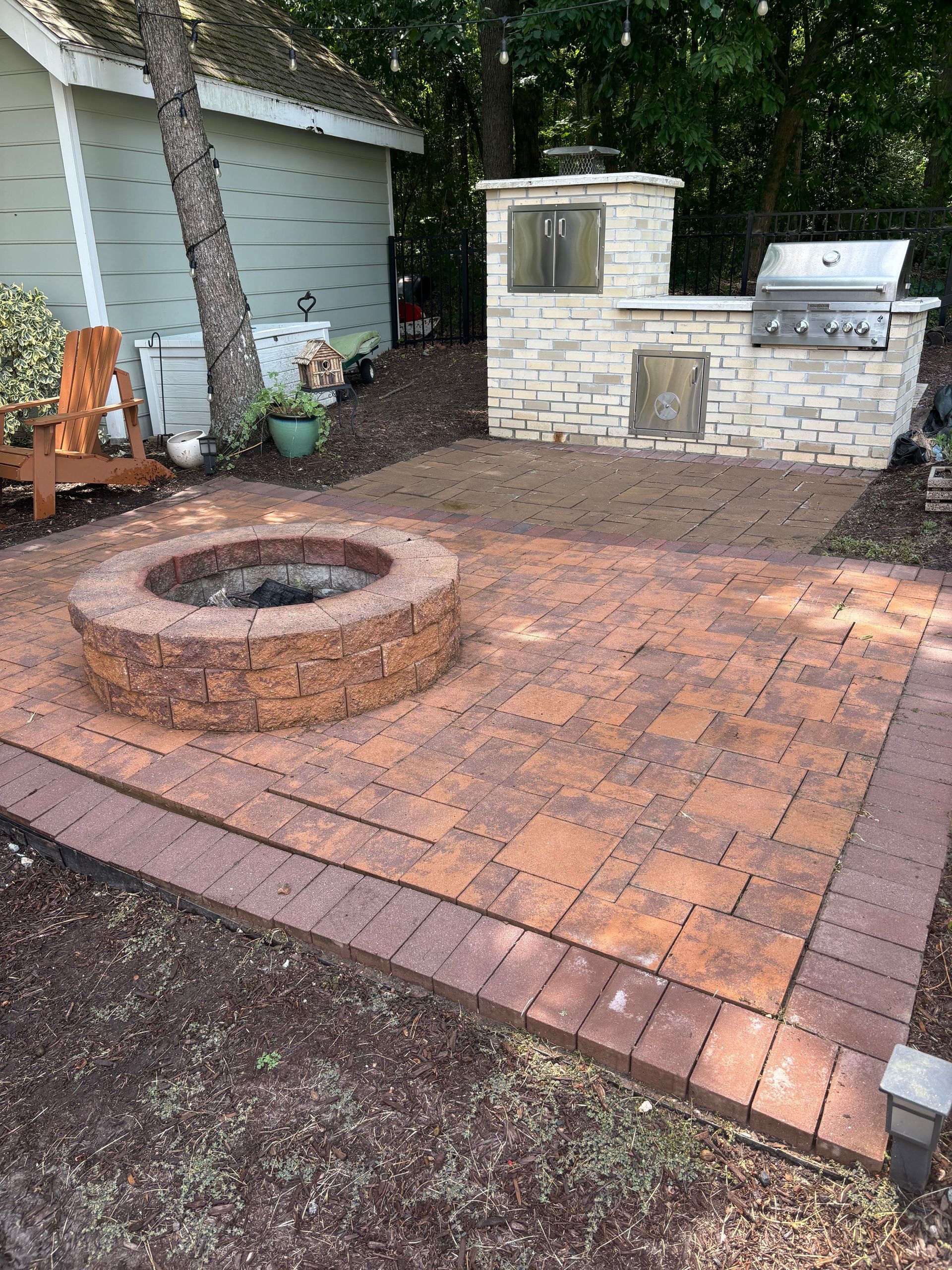 There is a fire pit in the middle of the patio.