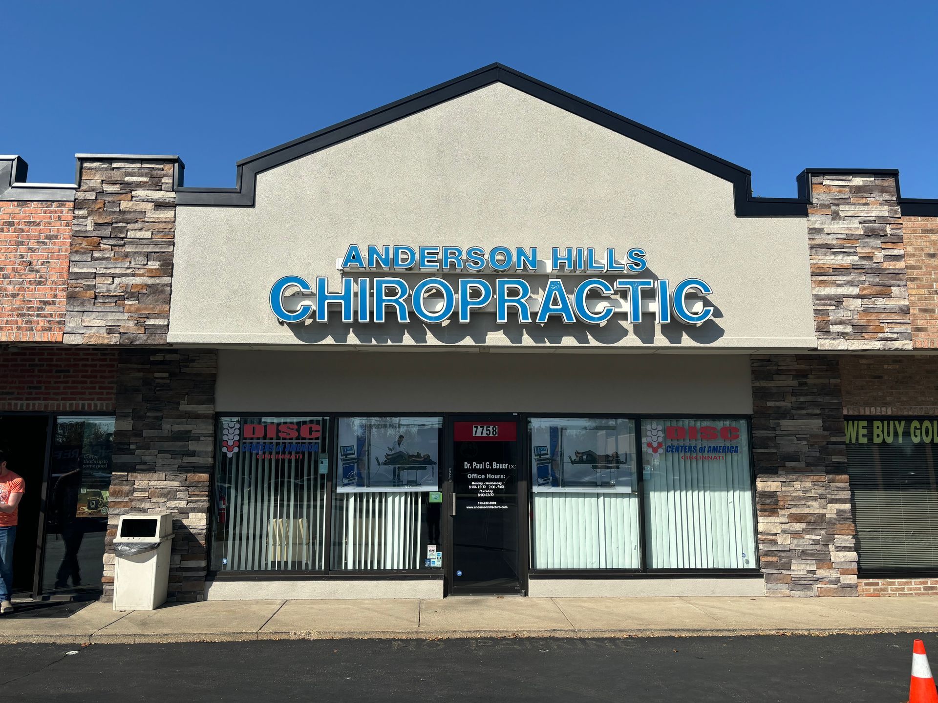 Anderson Hills Chiropractic storefront with blue neon sign and brick facade.