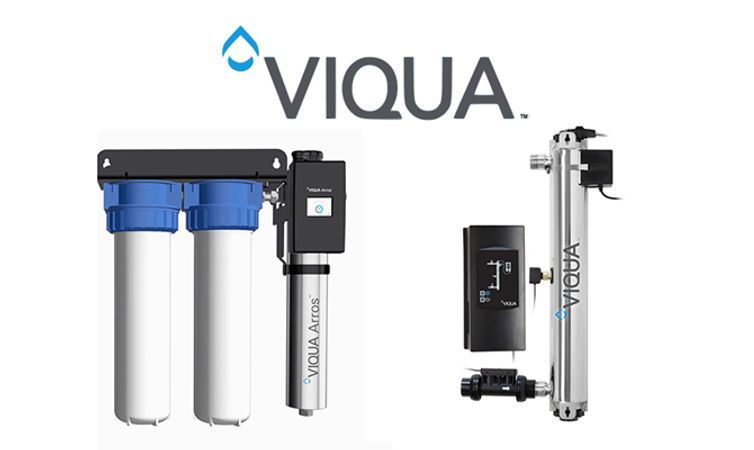 Water softener tank with control valve beside a bag of green sand filter media