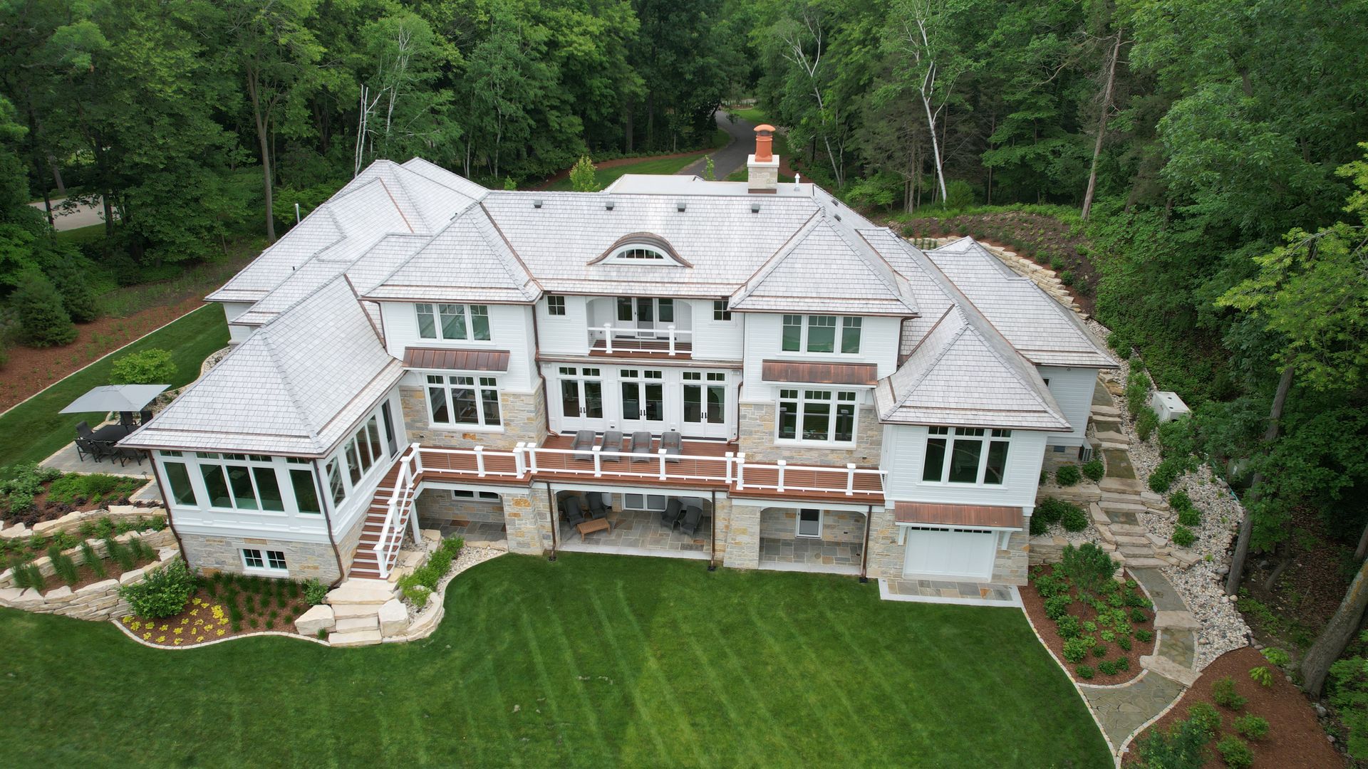 An aerial view of a large house surrounded by trees.