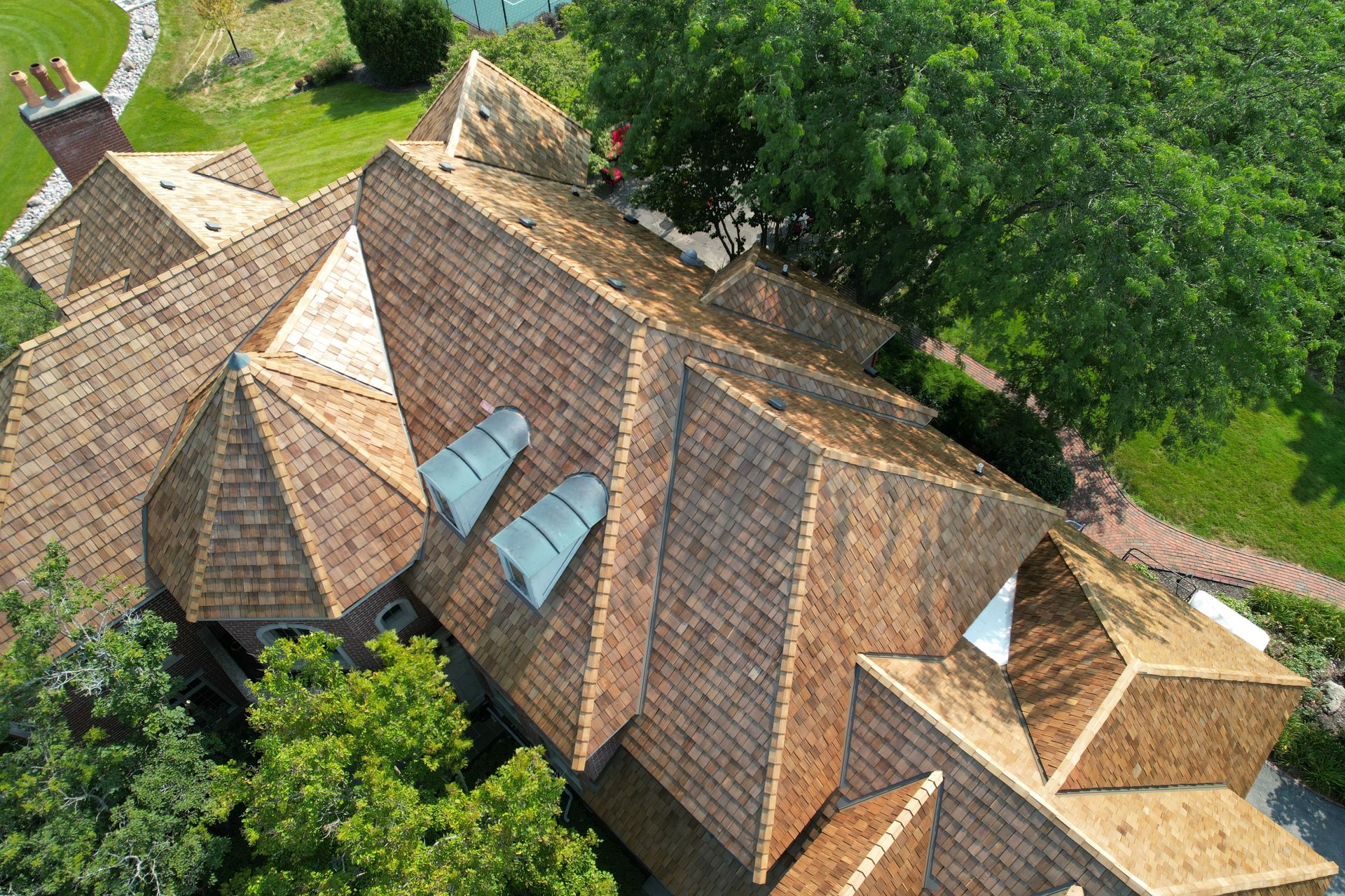 An aerial view of a house with a wooden roof.
