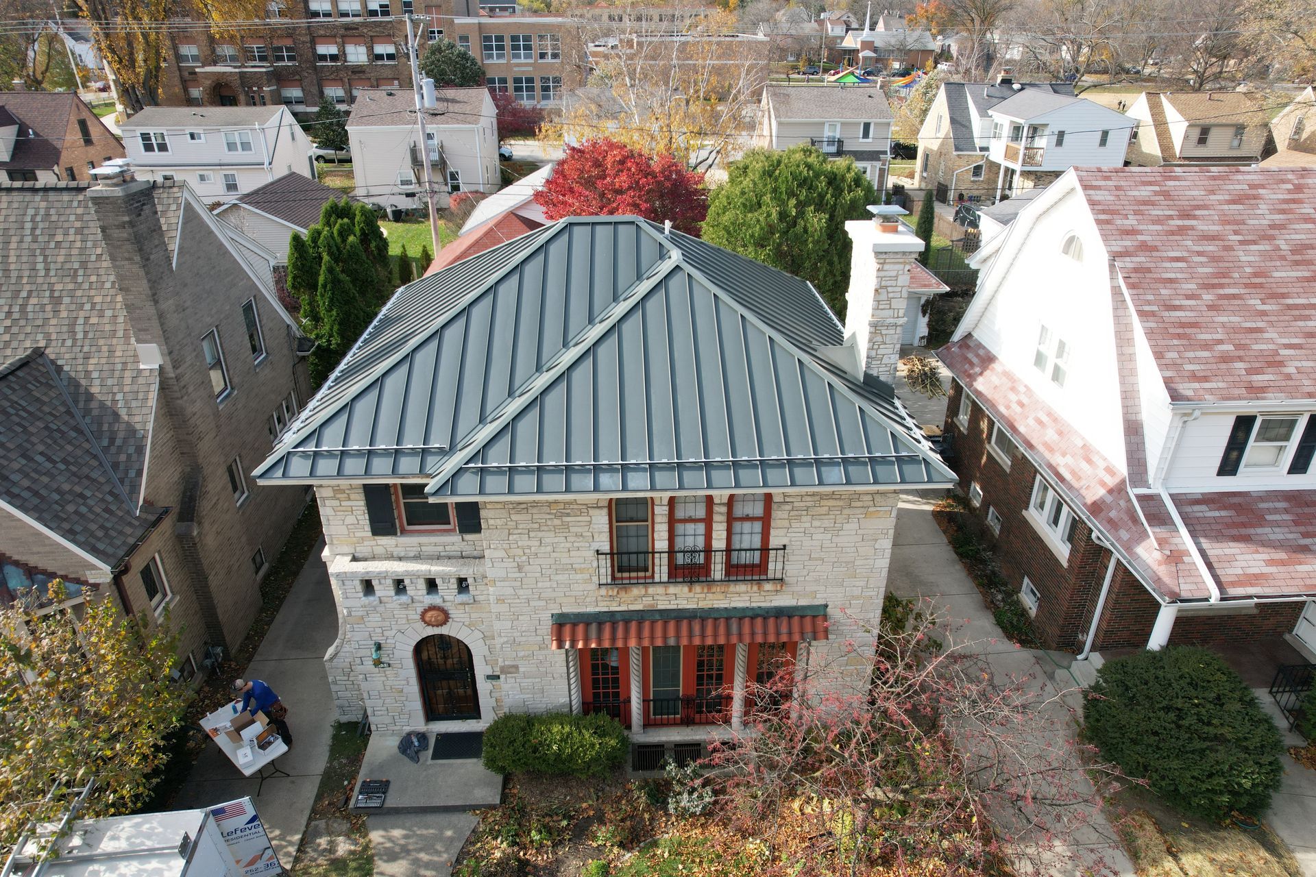 An aerial view of a house with a metal roof.