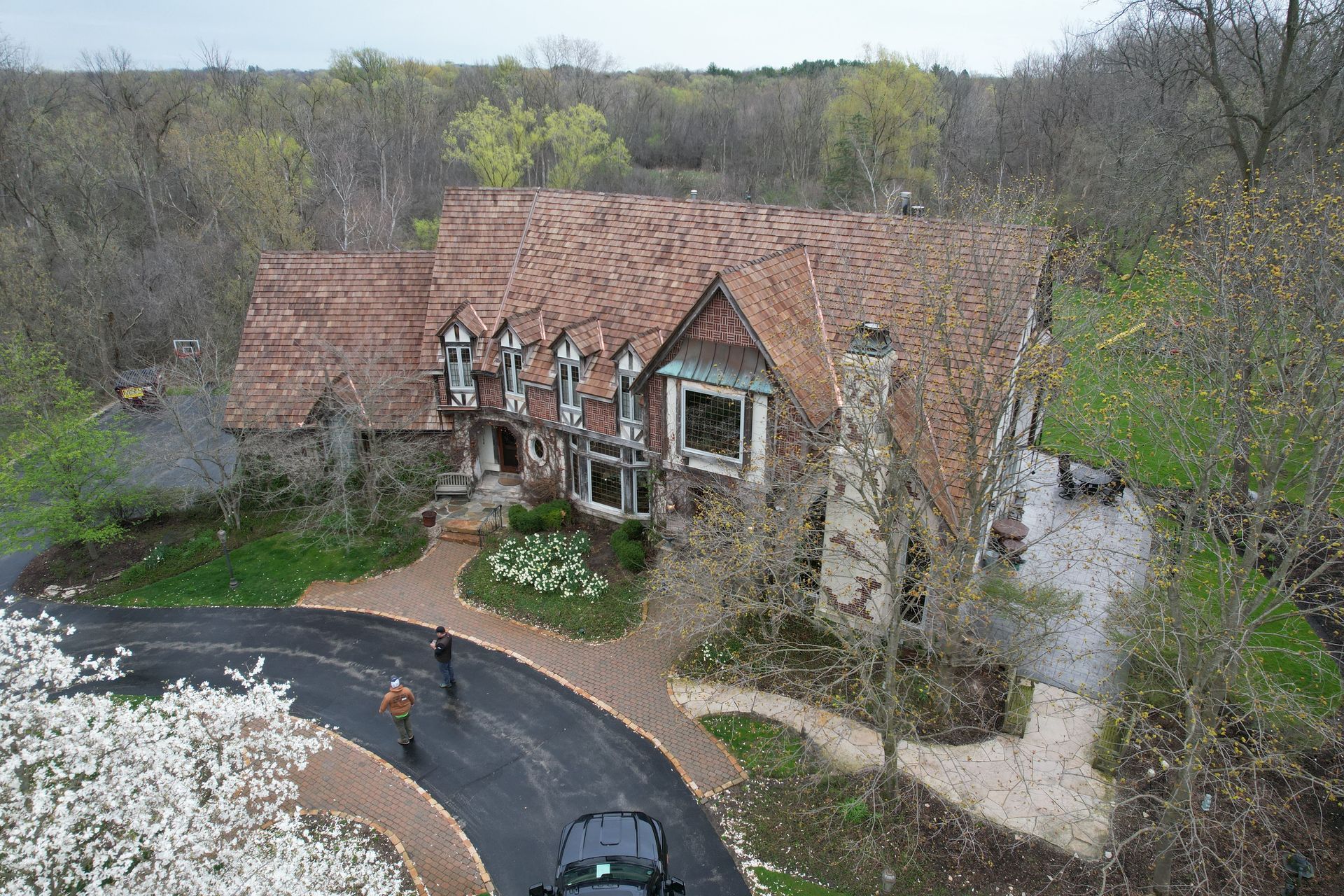 An aerial view of a house with a car parked in front of it.