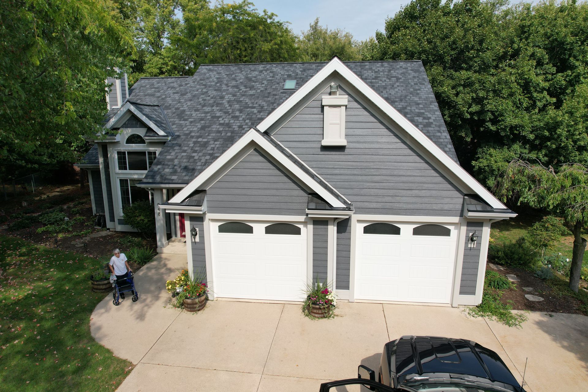 An aerial view of a house with a car parked in front of it.