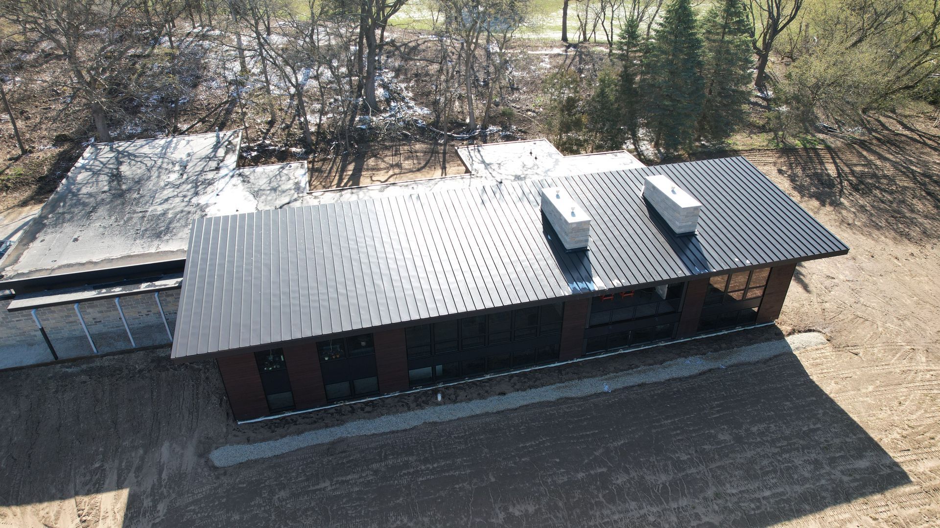 An aerial view of a house with a black roof.