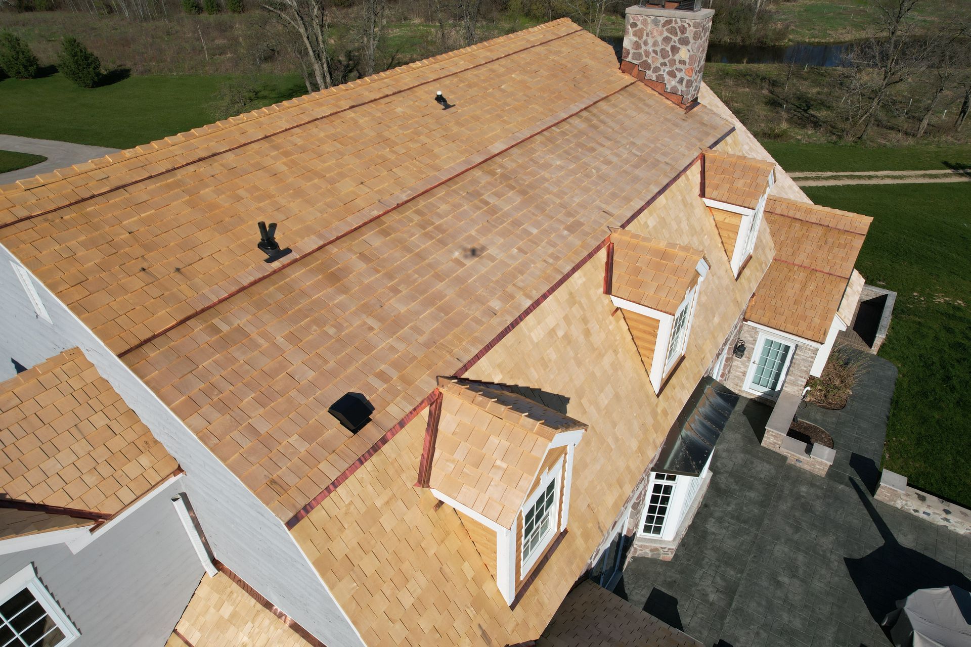 An aerial view of a large house with a wooden roof.