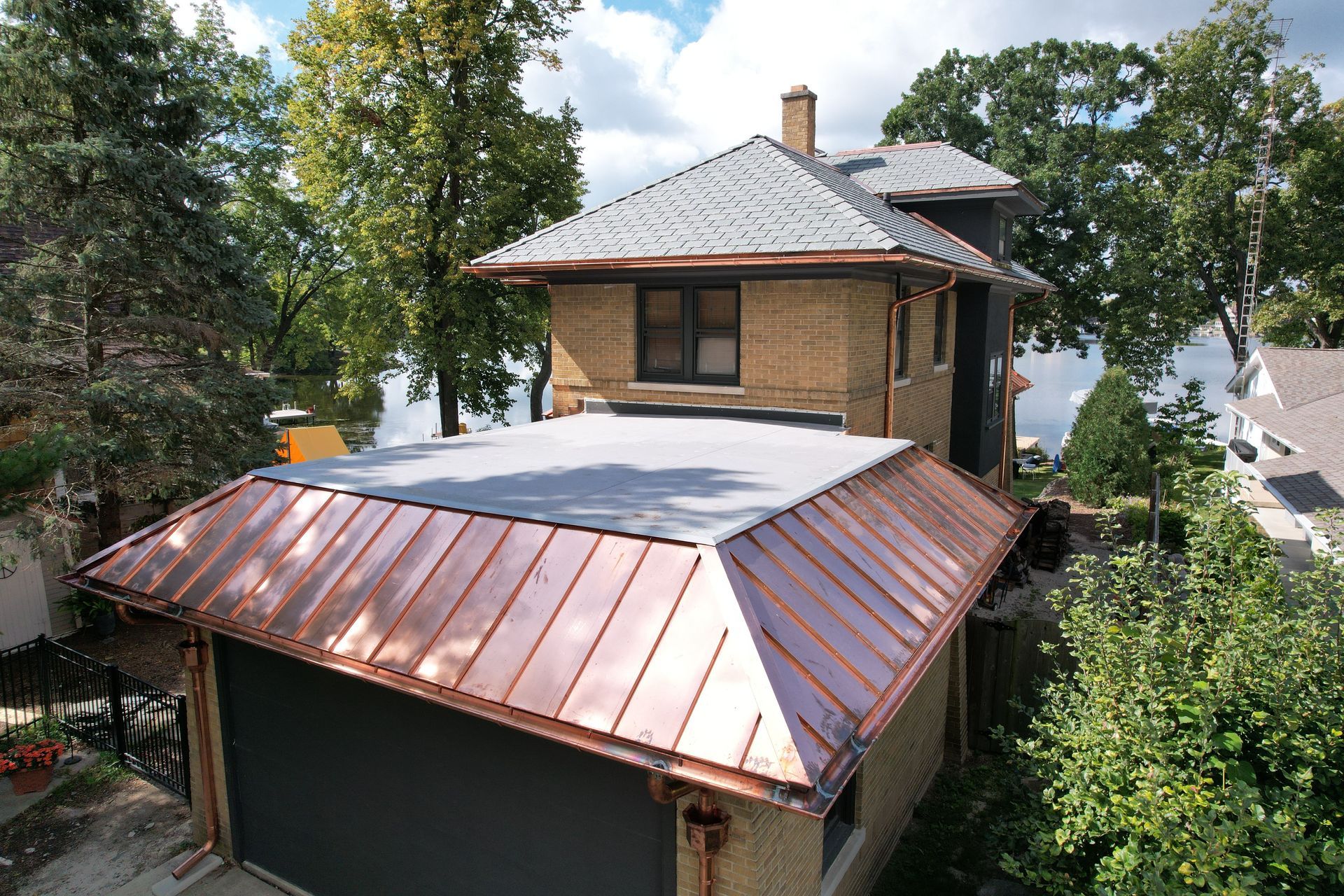 An aerial view of a house with a copper roof.