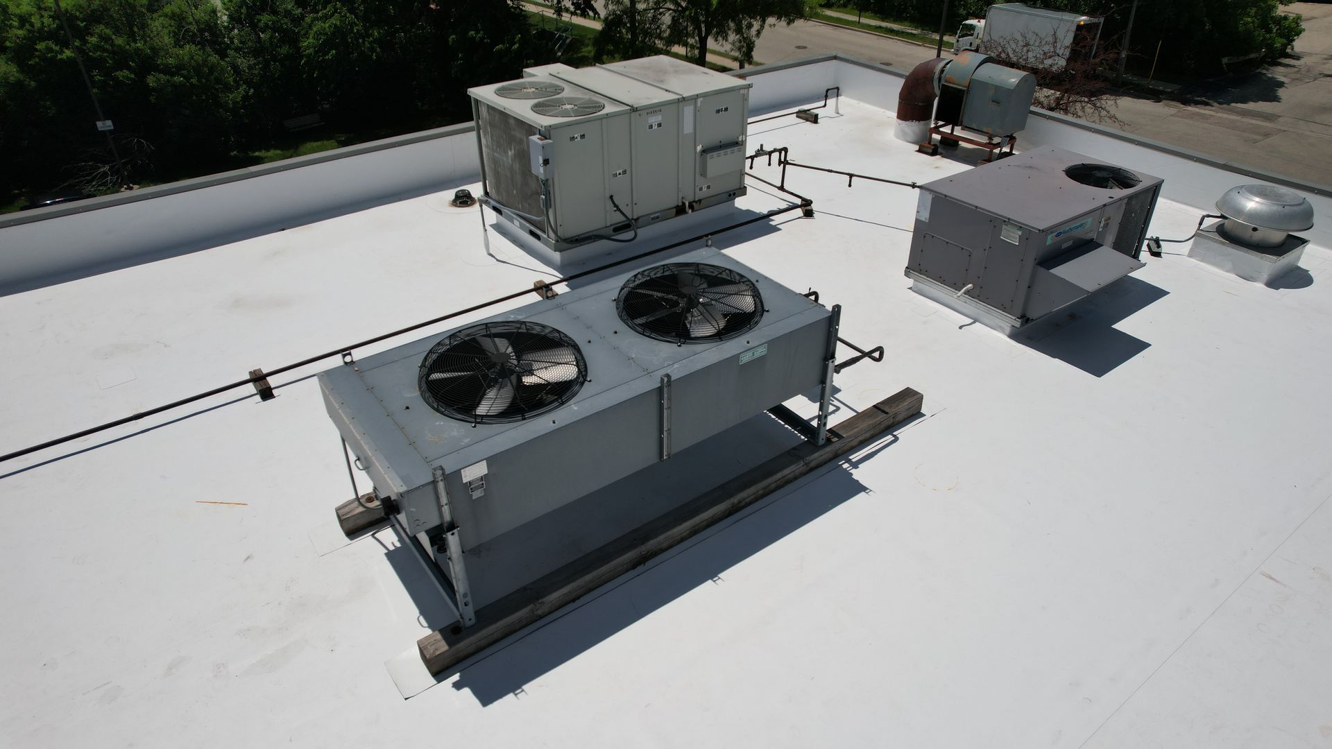 A white roof with a lot of air conditioning equipment on it.