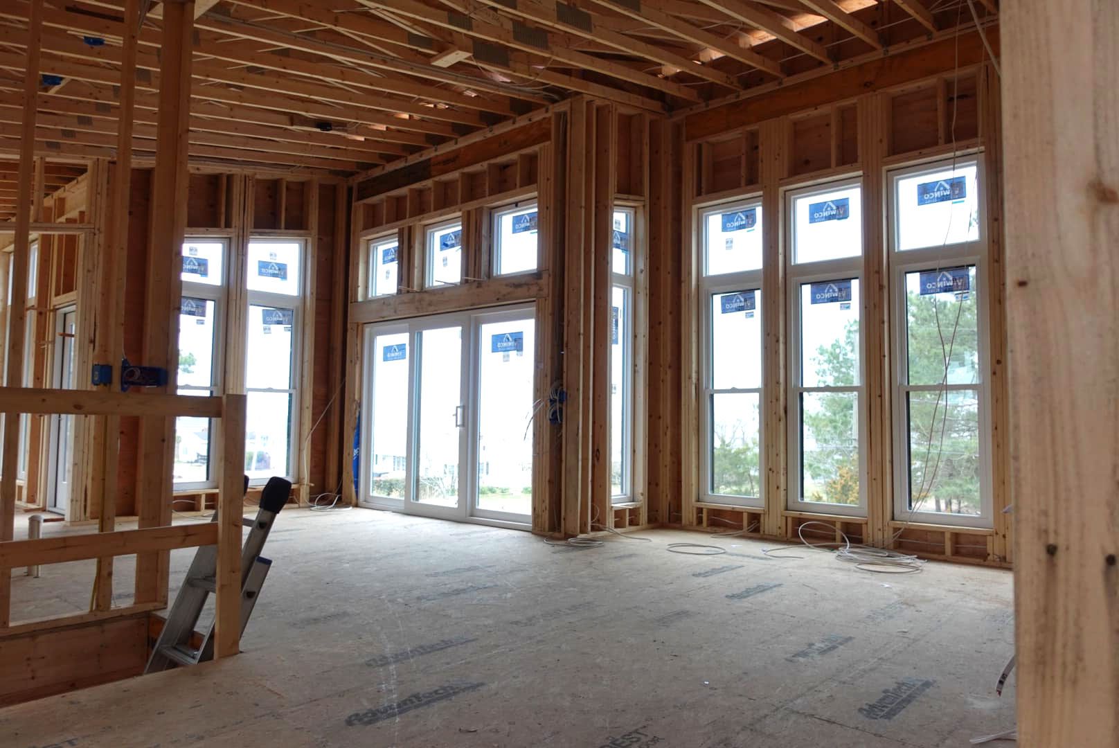 The inside of a house under construction with a lot of windows.
