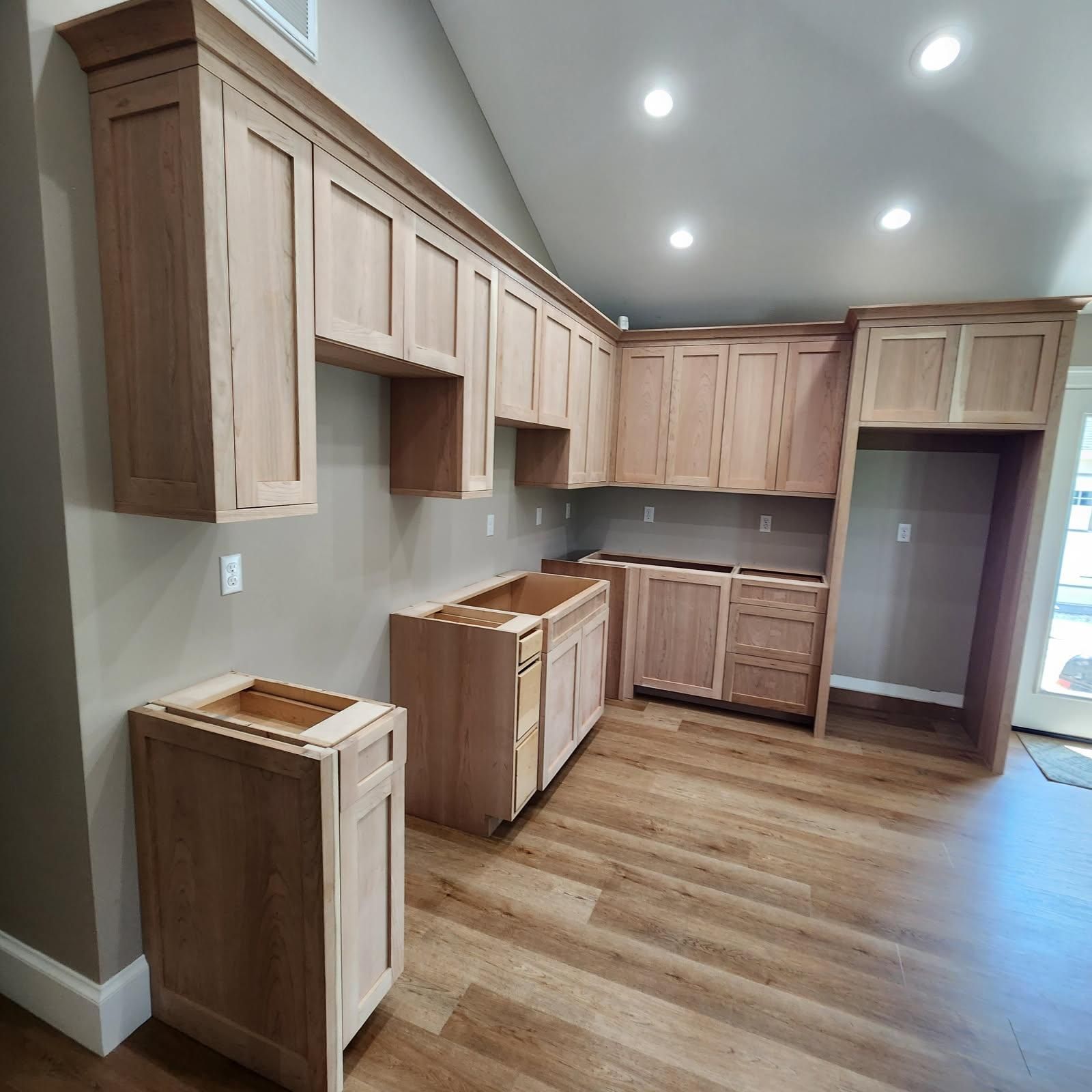 A kitchen with wooden cabinets and hardwood floors