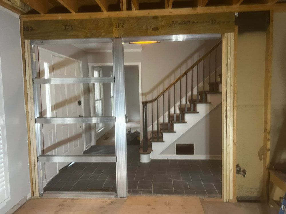 A room with a staircase and a sliding glass door